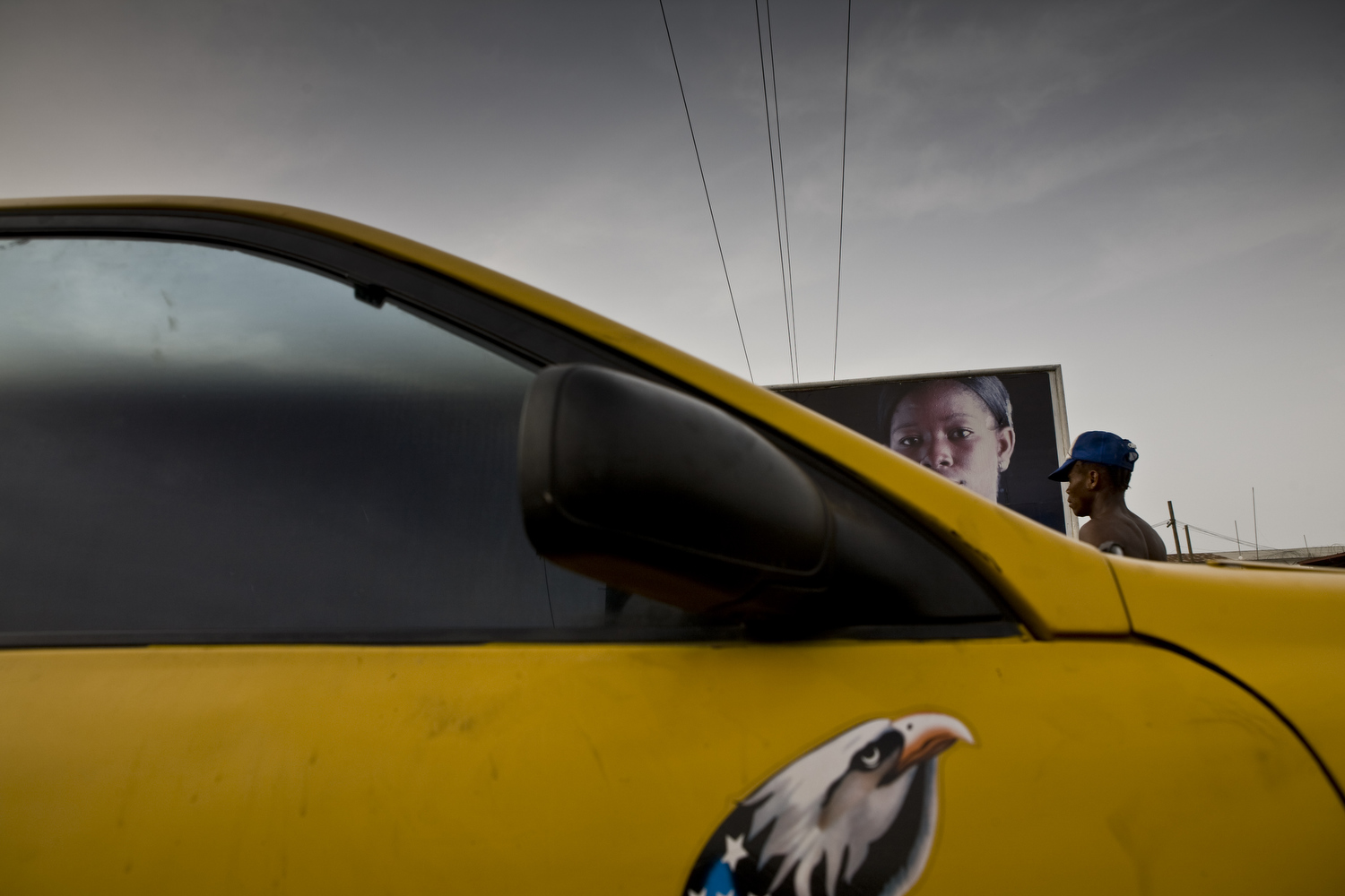 A taxi drives by an antirape billboard in Monrovia, the capital of Liberia.