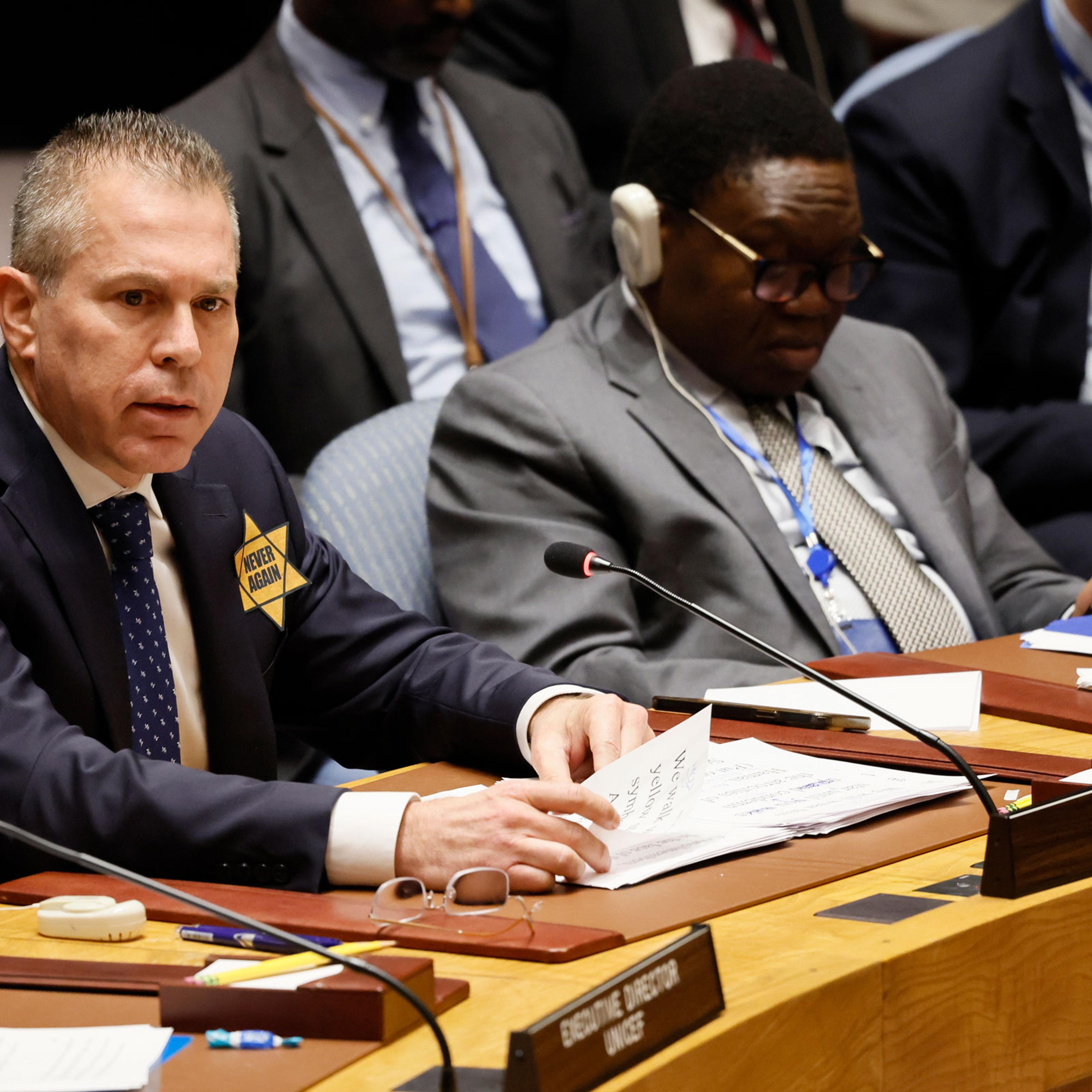 Israeli United Nations Ambassador Gilad Erdan, wearing a yellow star with the words “Never Again,” speaks during a Security Council meeting on the Israel-Hamas war at U.N. headquarters
