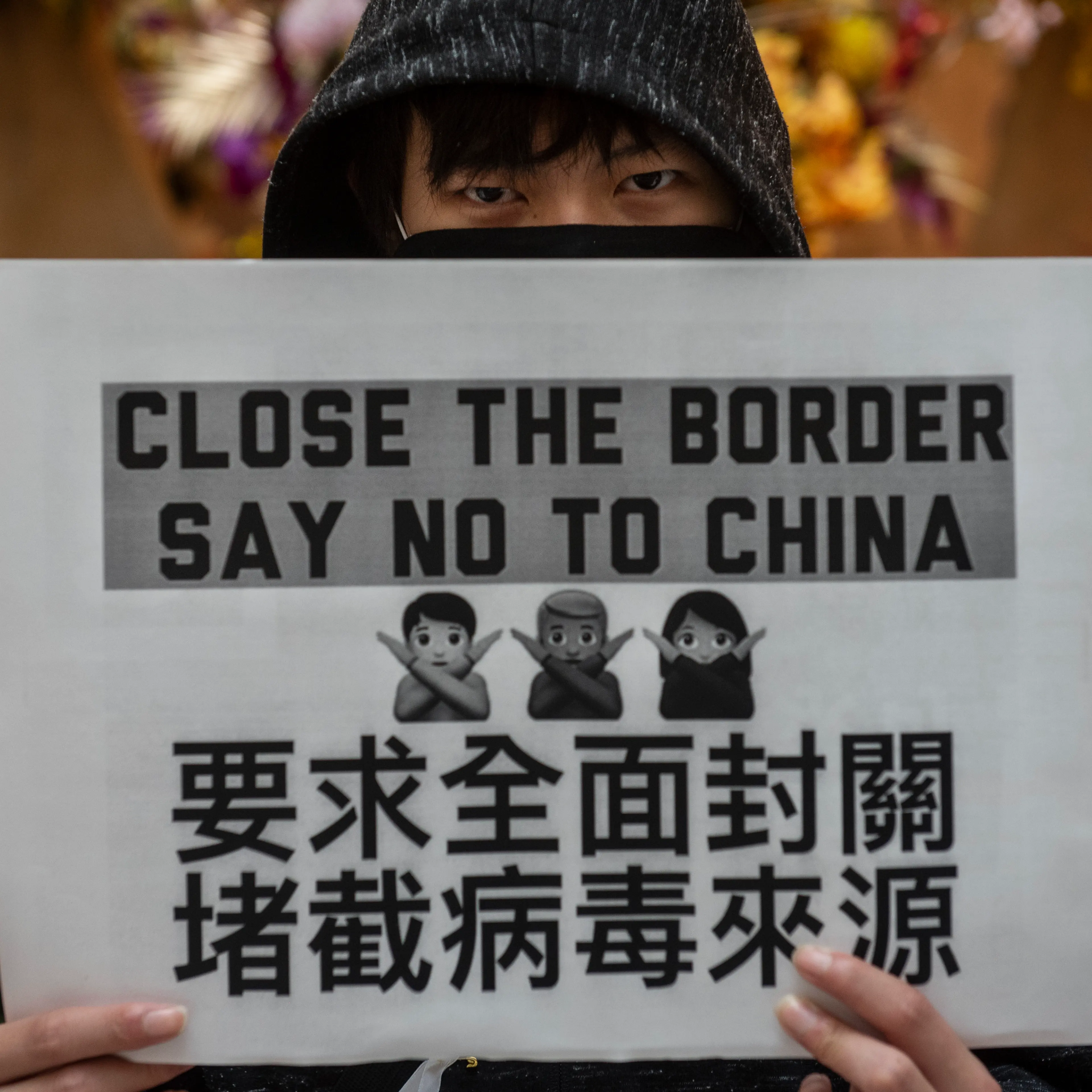A demonstrator holds a placard during a protest calling on