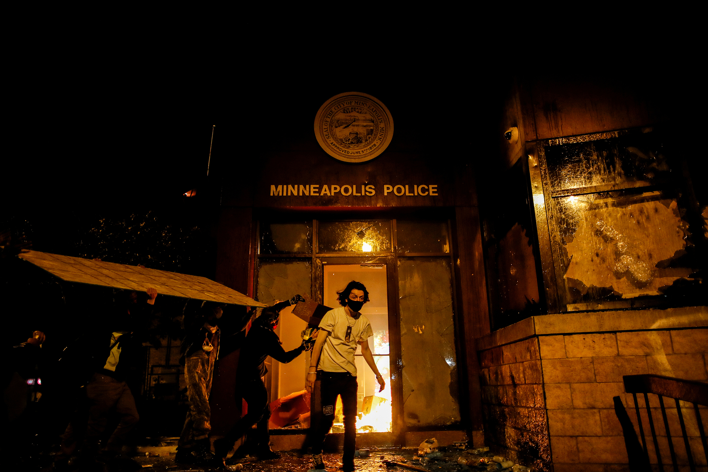 Protesters set fire to the entrance of a police precinct in Minneapolis on May 28 as demonstrations continue in the wake of George Floyd's death. Three days earlier, a white police officer was caught on a bystander's video pressing his knee into the neck