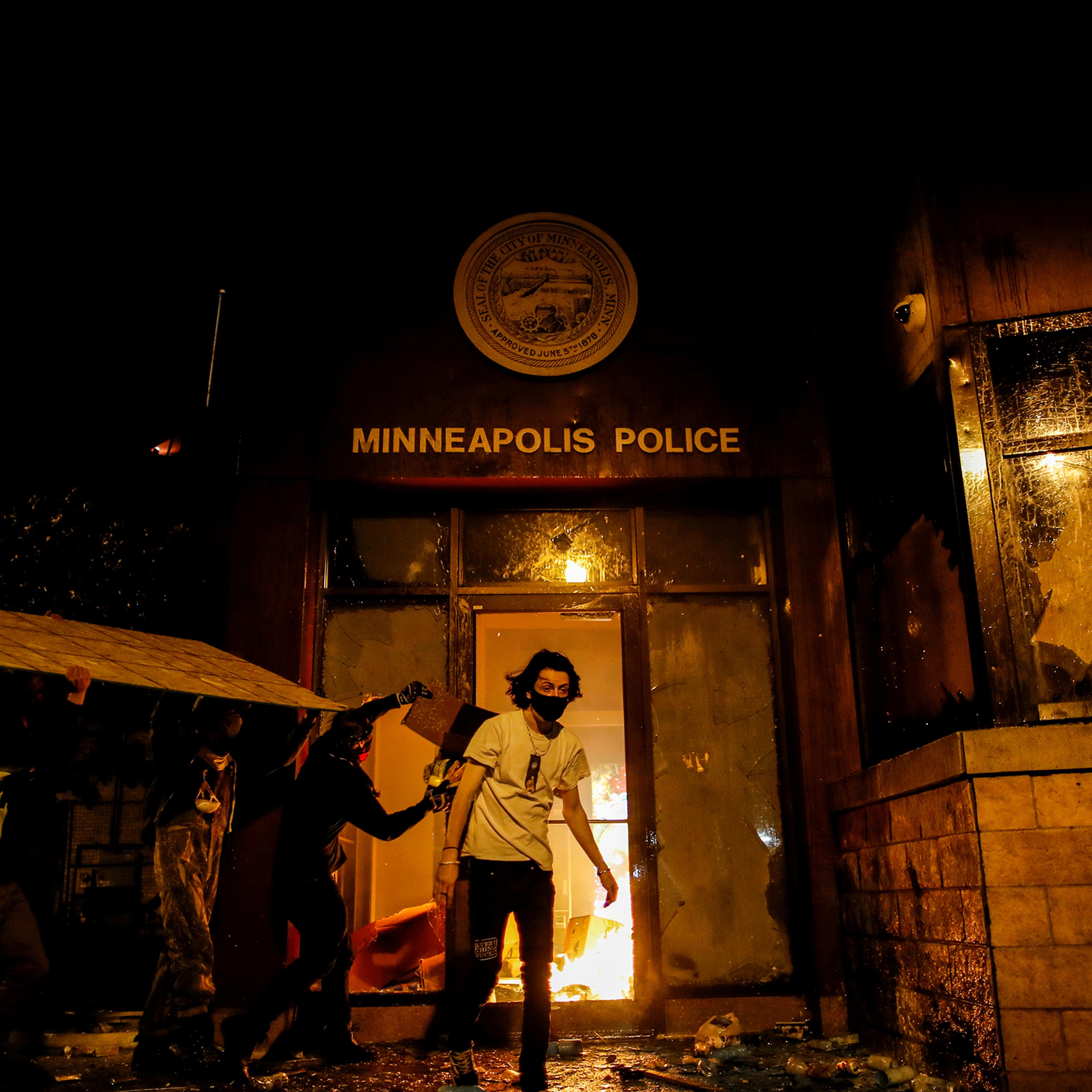 Protesters set fire to the entrance of a police precinct in Minneapolis on May 28 as demonstrations continue in the wake of George Floyd's death. Three days earlier, a white police officer was caught on a bystander's video pressing his knee into the neck