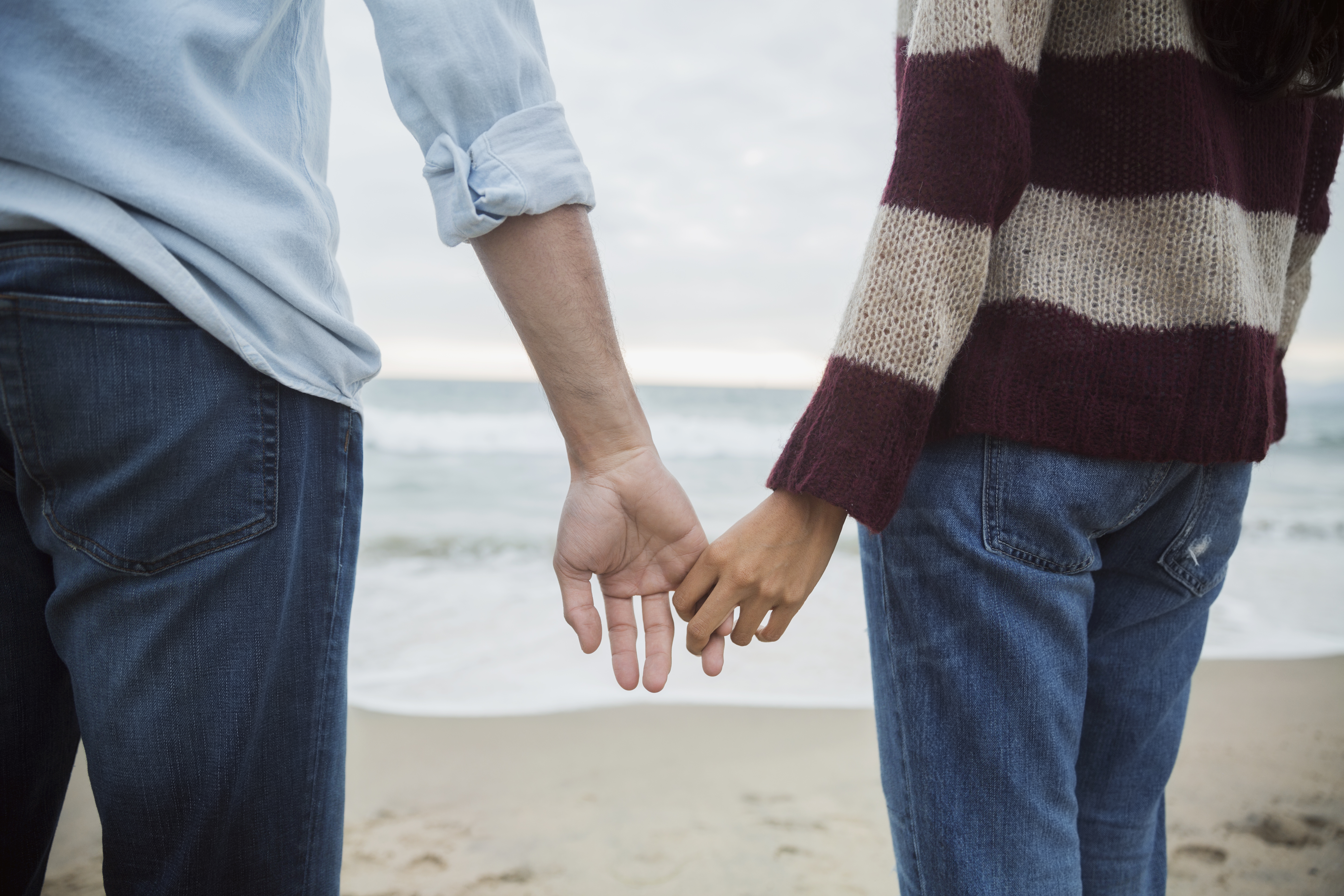 Couple holding hands on beach