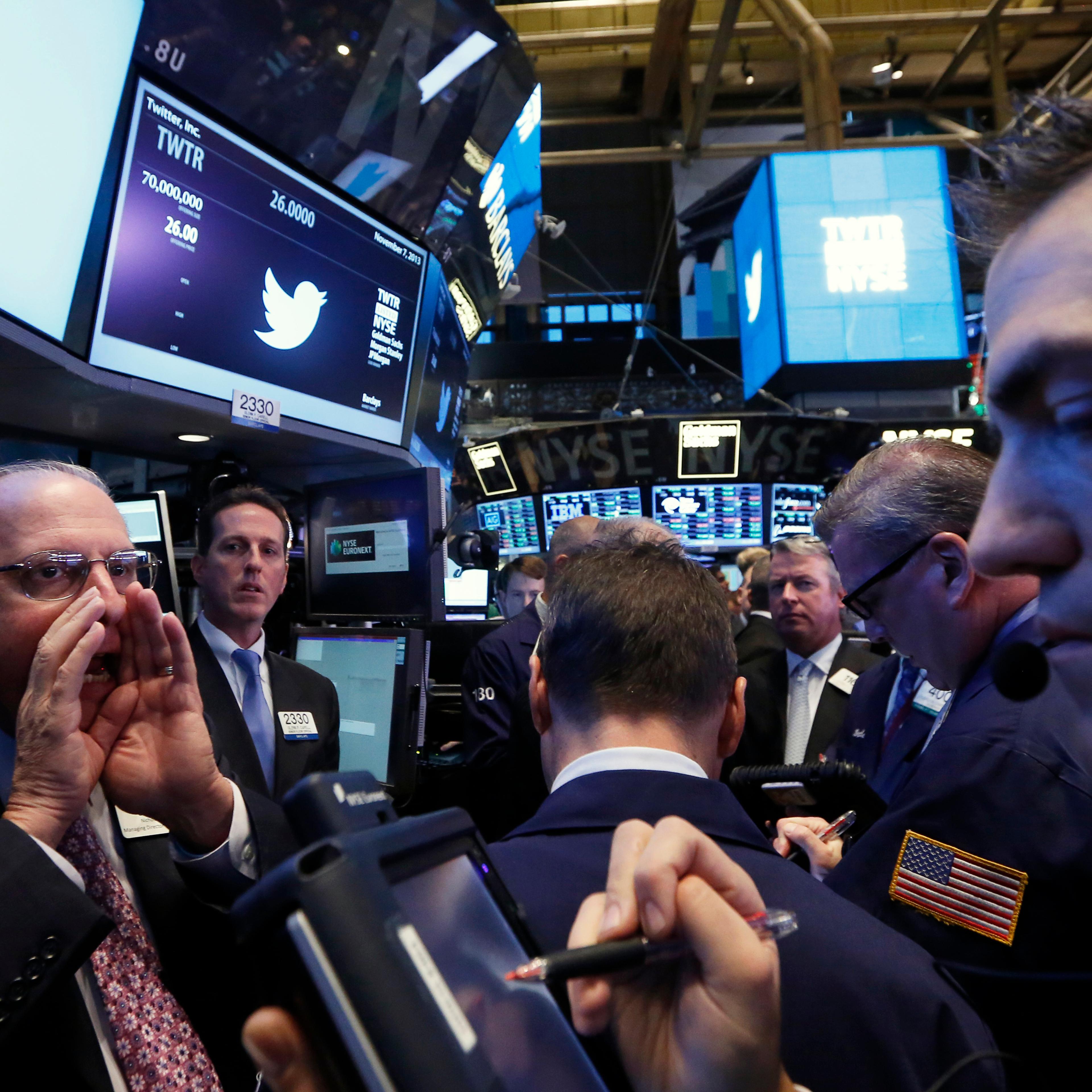 Traders get to work during Twitter Inc.'s IPO on the floor of the New York Stock Exchange in New York Nov. 7, 2013.