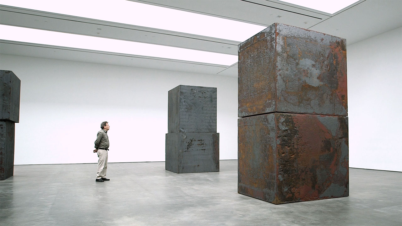 Philip Glass observing Richard Serra's "Equal" at David Zwirner gallery in New York