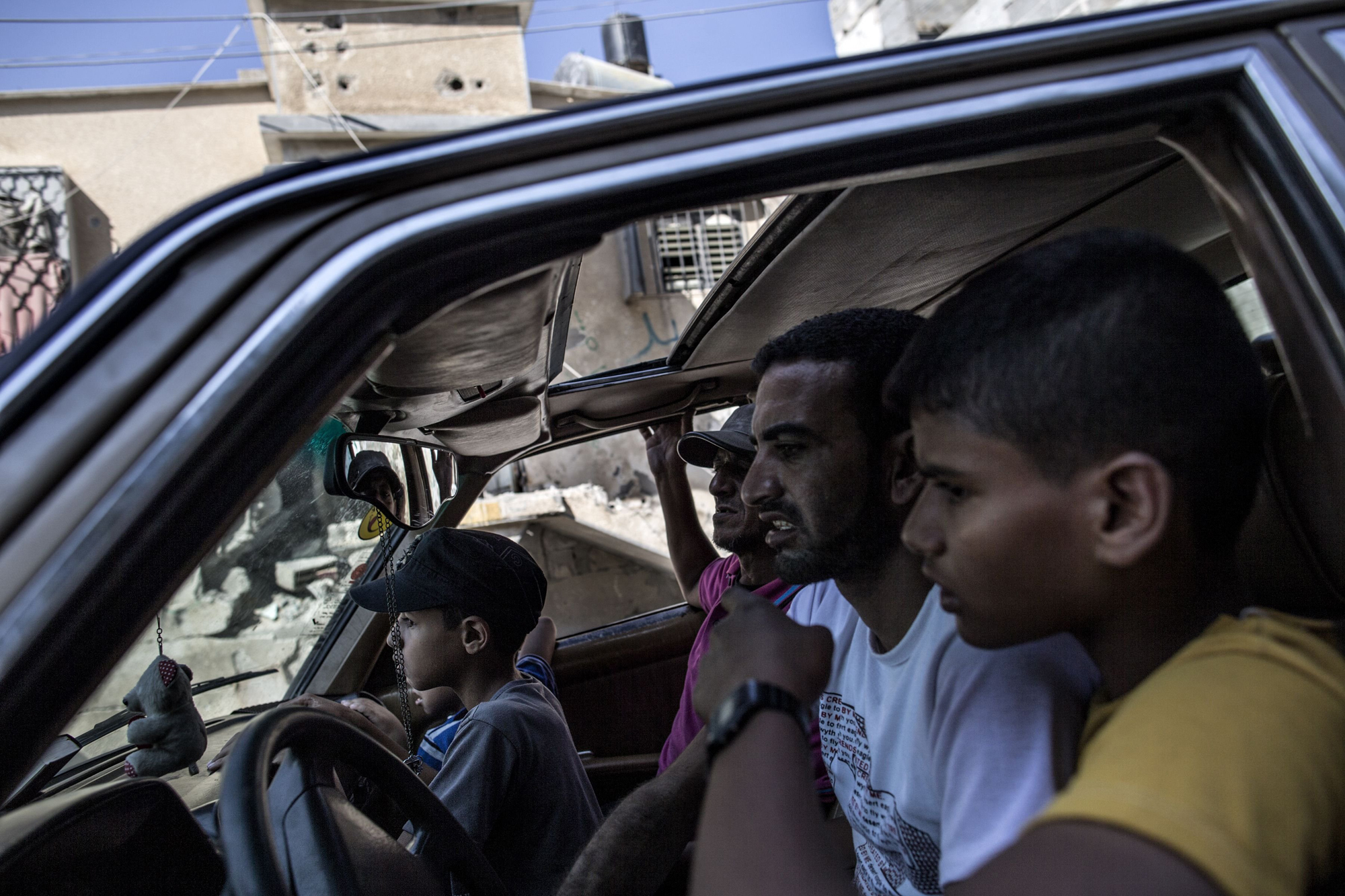 A Palestinian family from Gaza Strip's central Bureij refugee camp drives back to their district during the first hours of a failed truce on August 1, 2014.