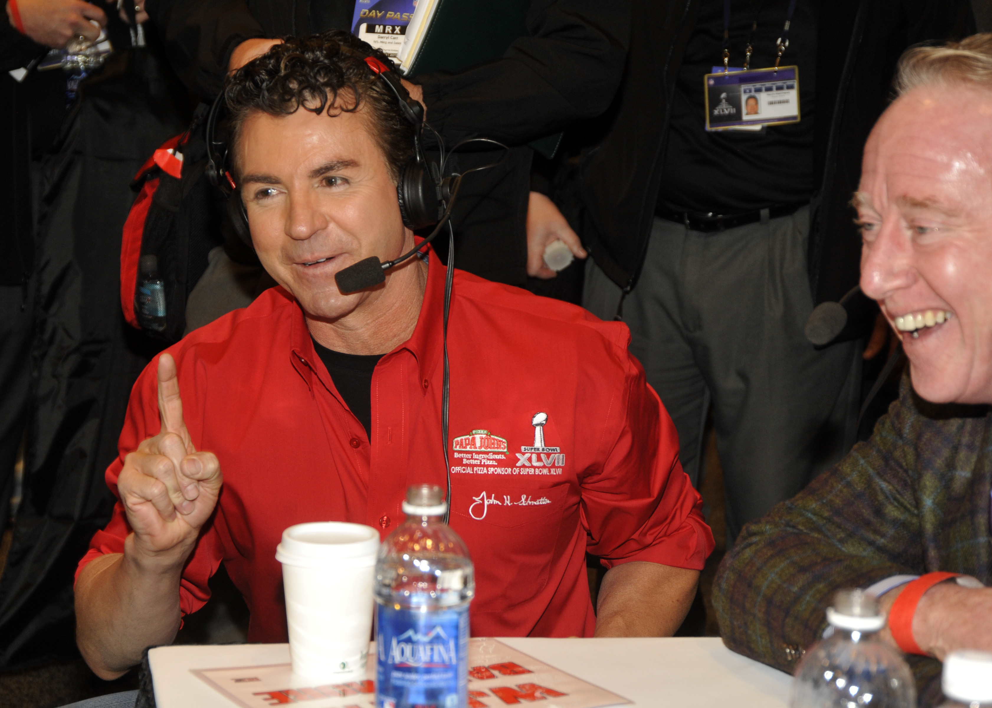 John Schnatter laughing at coin toss