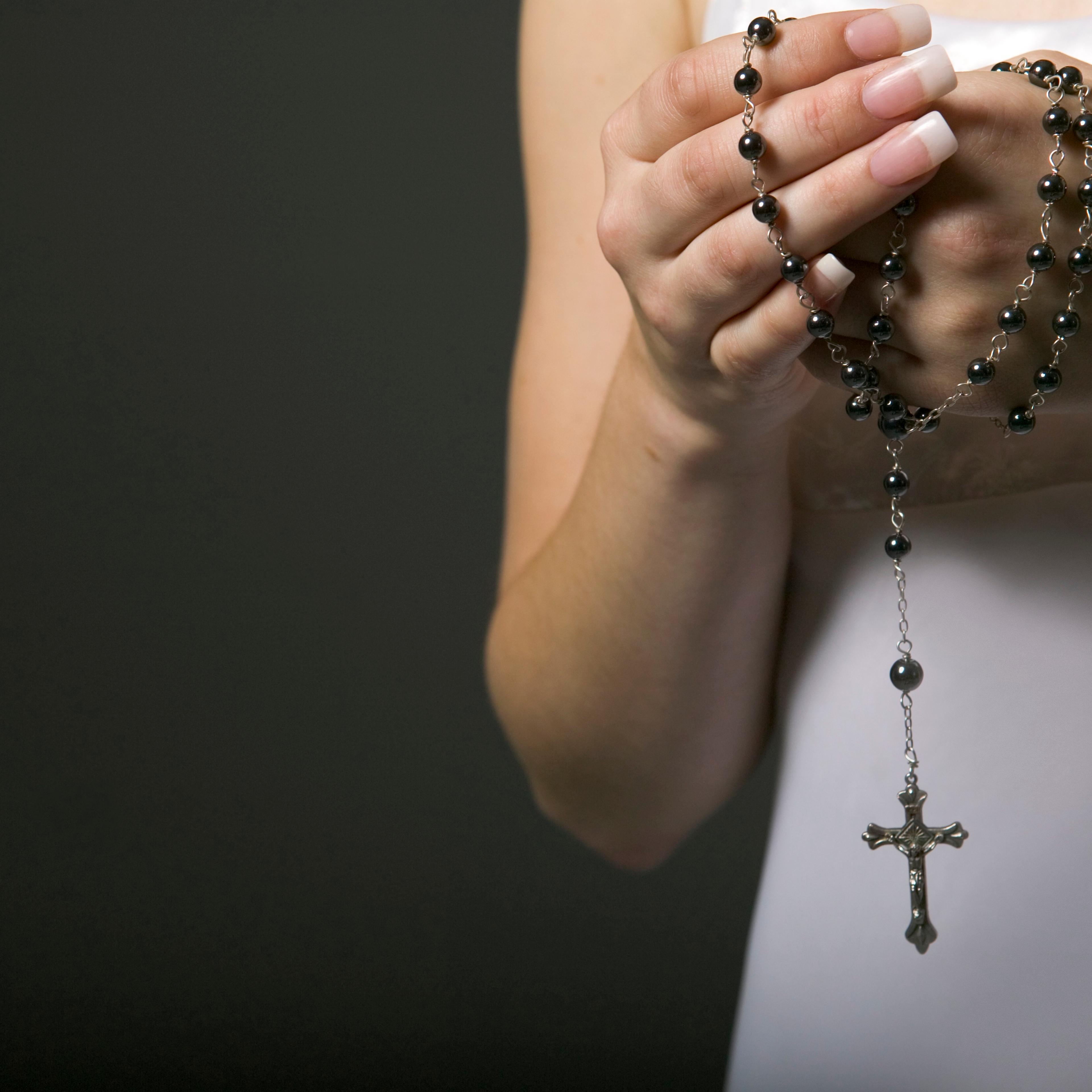 Woman holding rosary