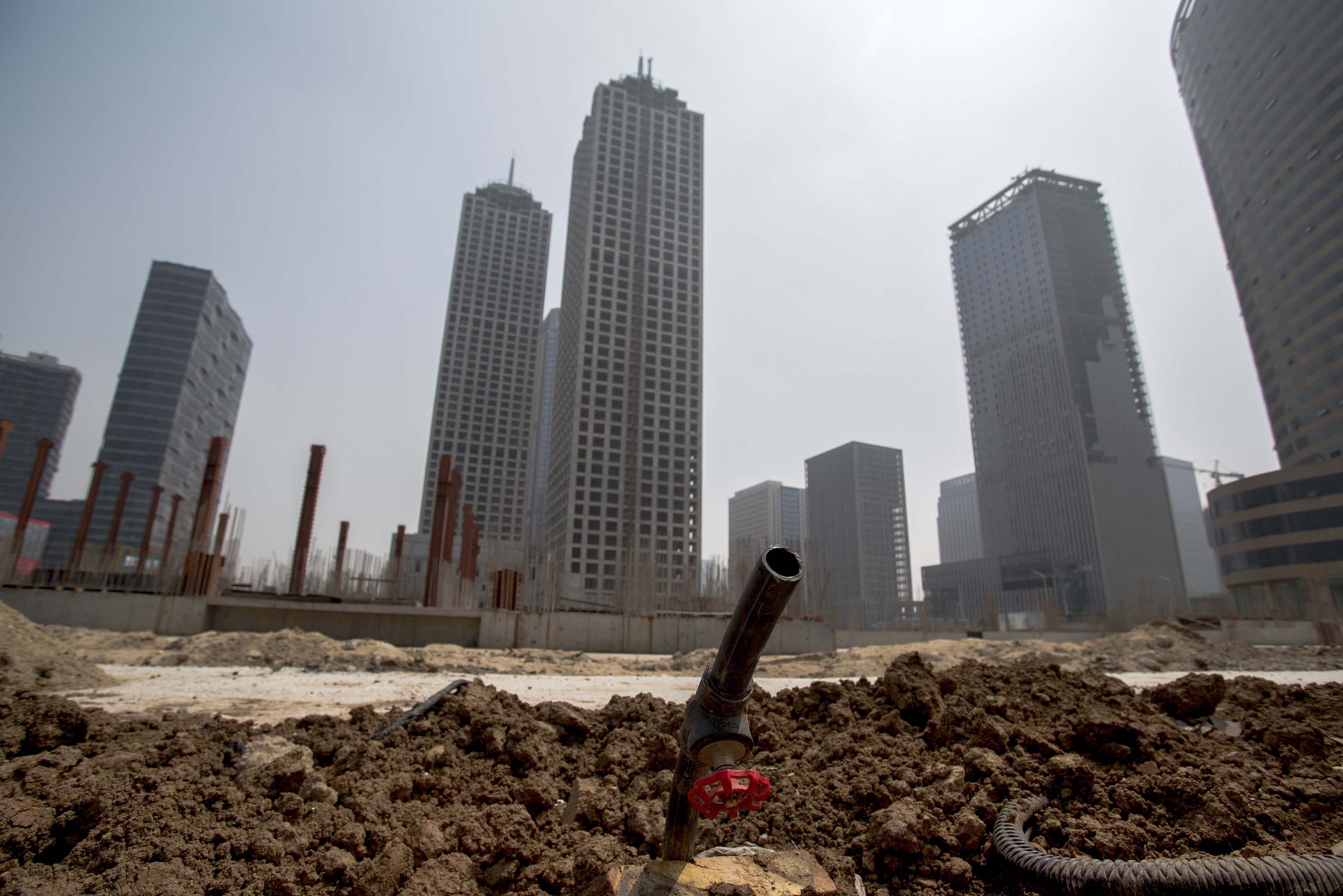 Unfinished buildings are left in the Chinese city of Tianjin, as the slowing property sector takes a toll on the economy