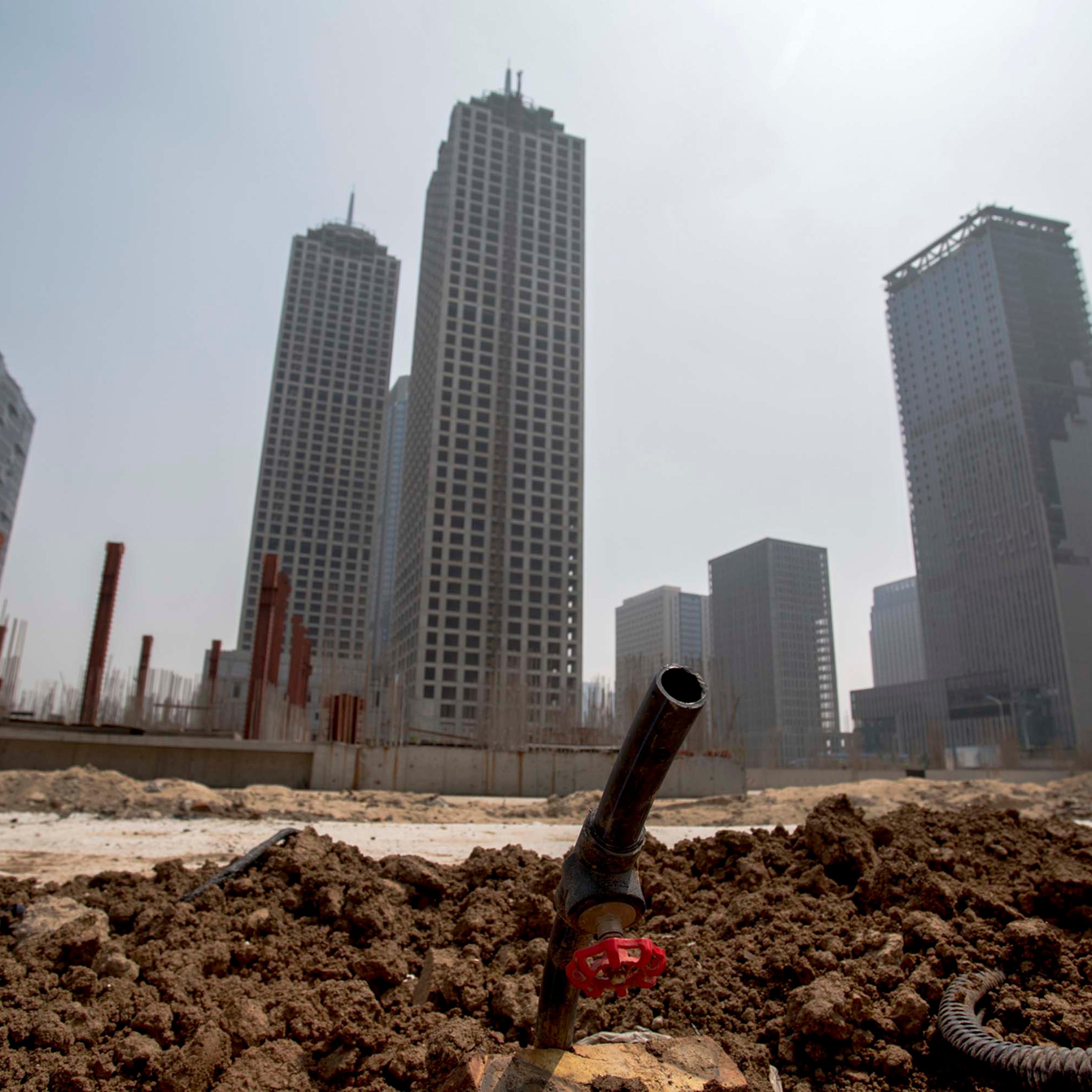 Unfinished buildings are left in the Chinese city of Tianjin, as the slowing property sector takes a toll on the economy