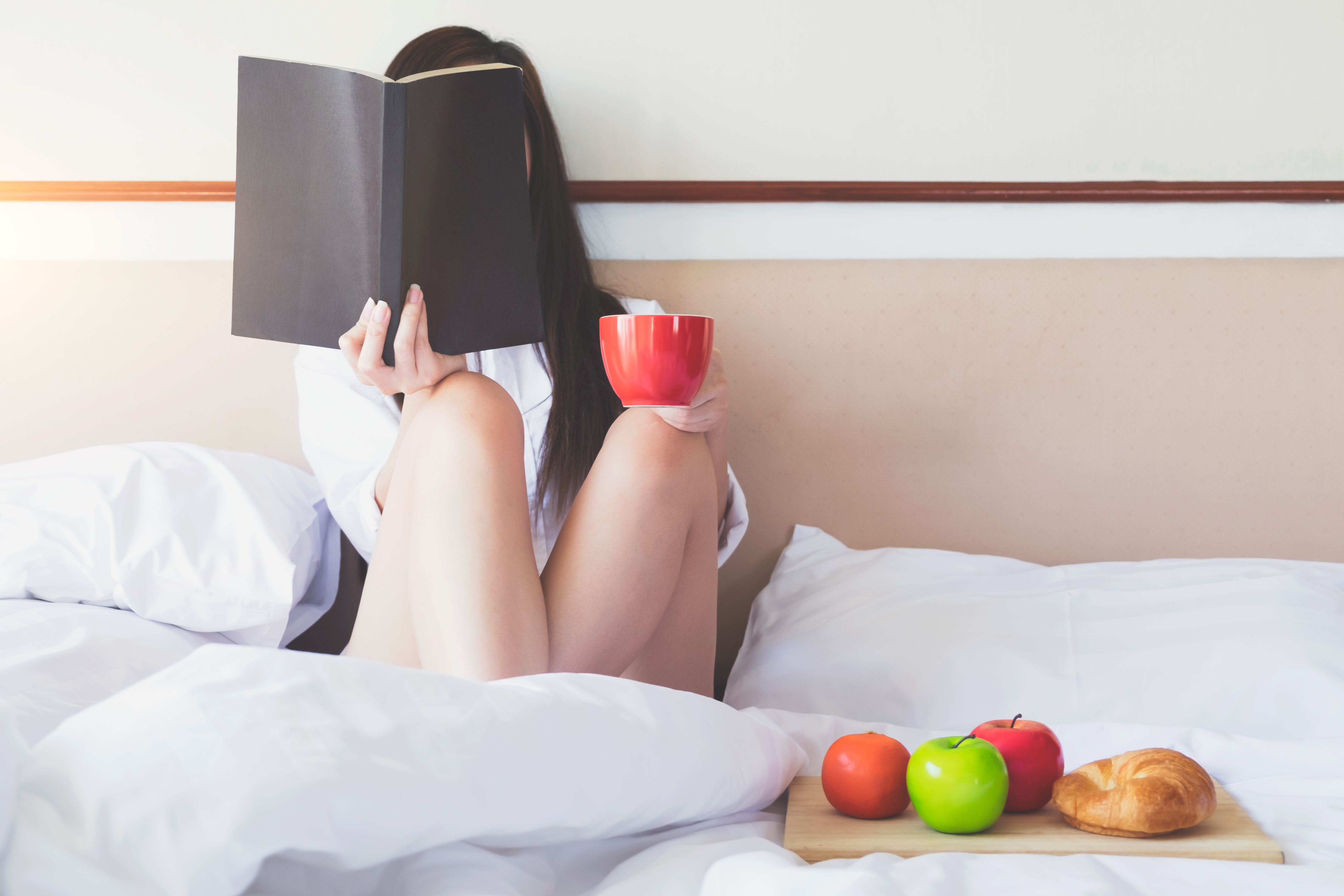 Woman Relaxing On Bed At Home