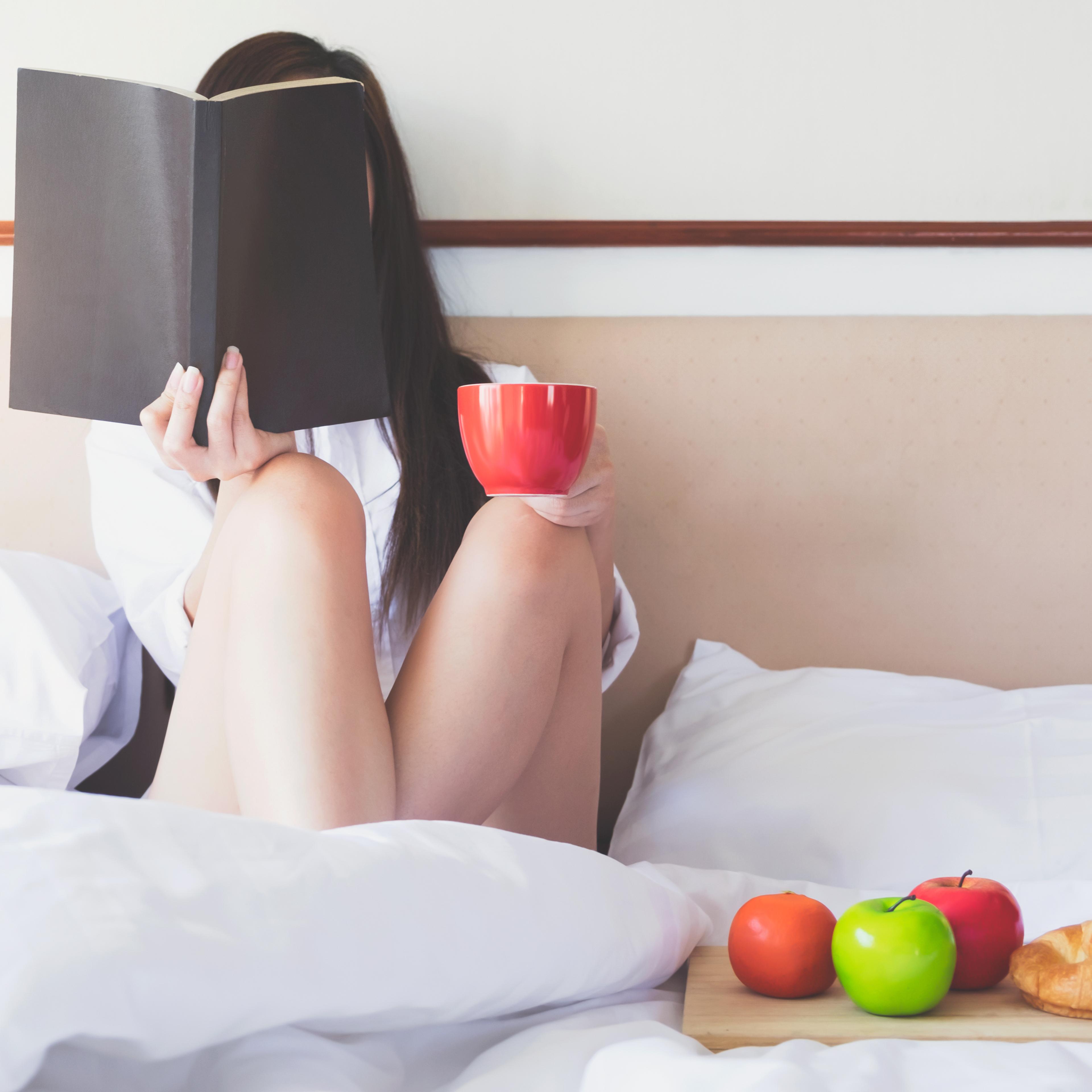 Woman Relaxing On Bed At Home