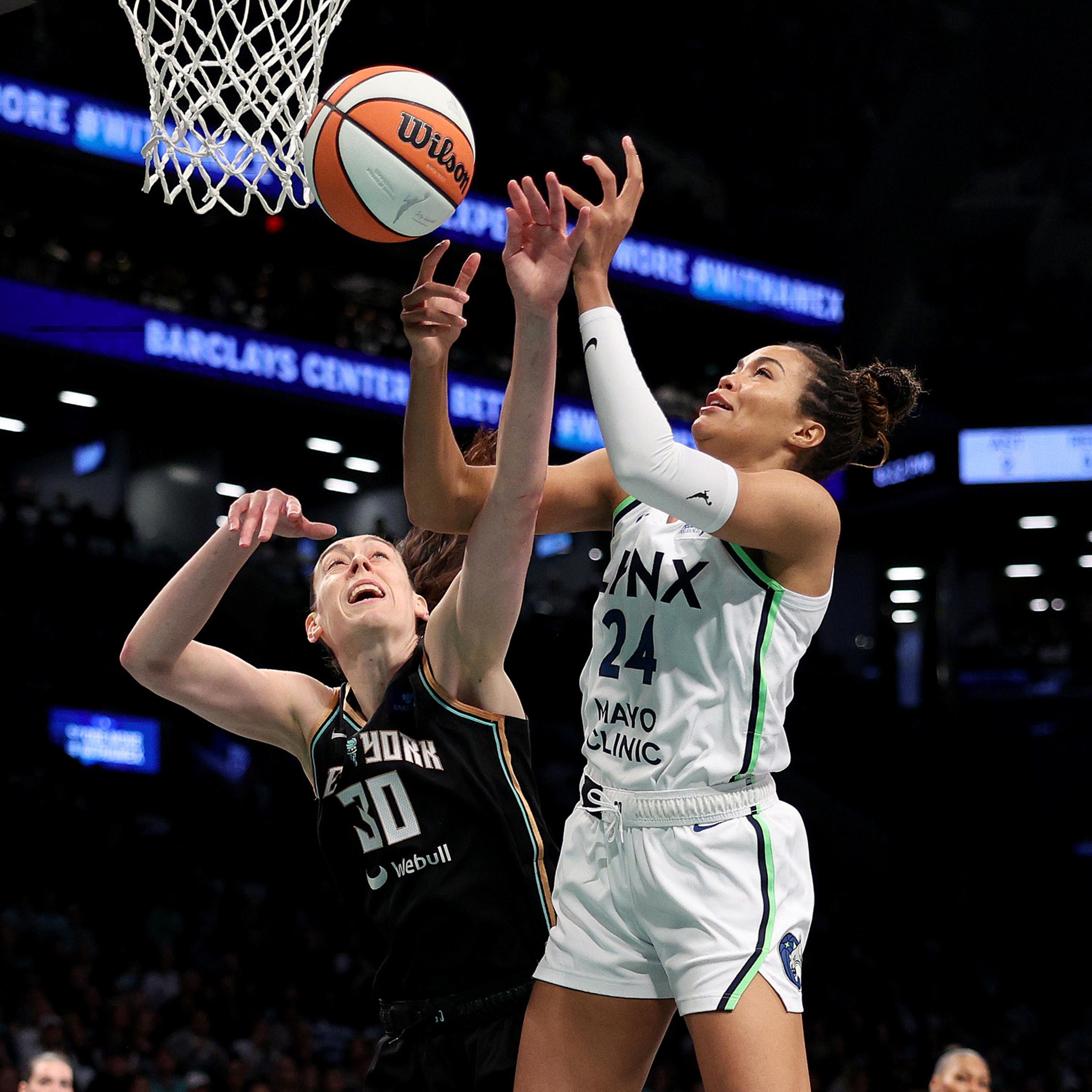 Napheesa Collier, #24 of the Minnesota Lynx, heads for the net as Breanna Stewart, #30 of the New York Liberty, defends during Game Five of the WNBA Finals at Barclays Center in New York on Oct. 20, 2024.