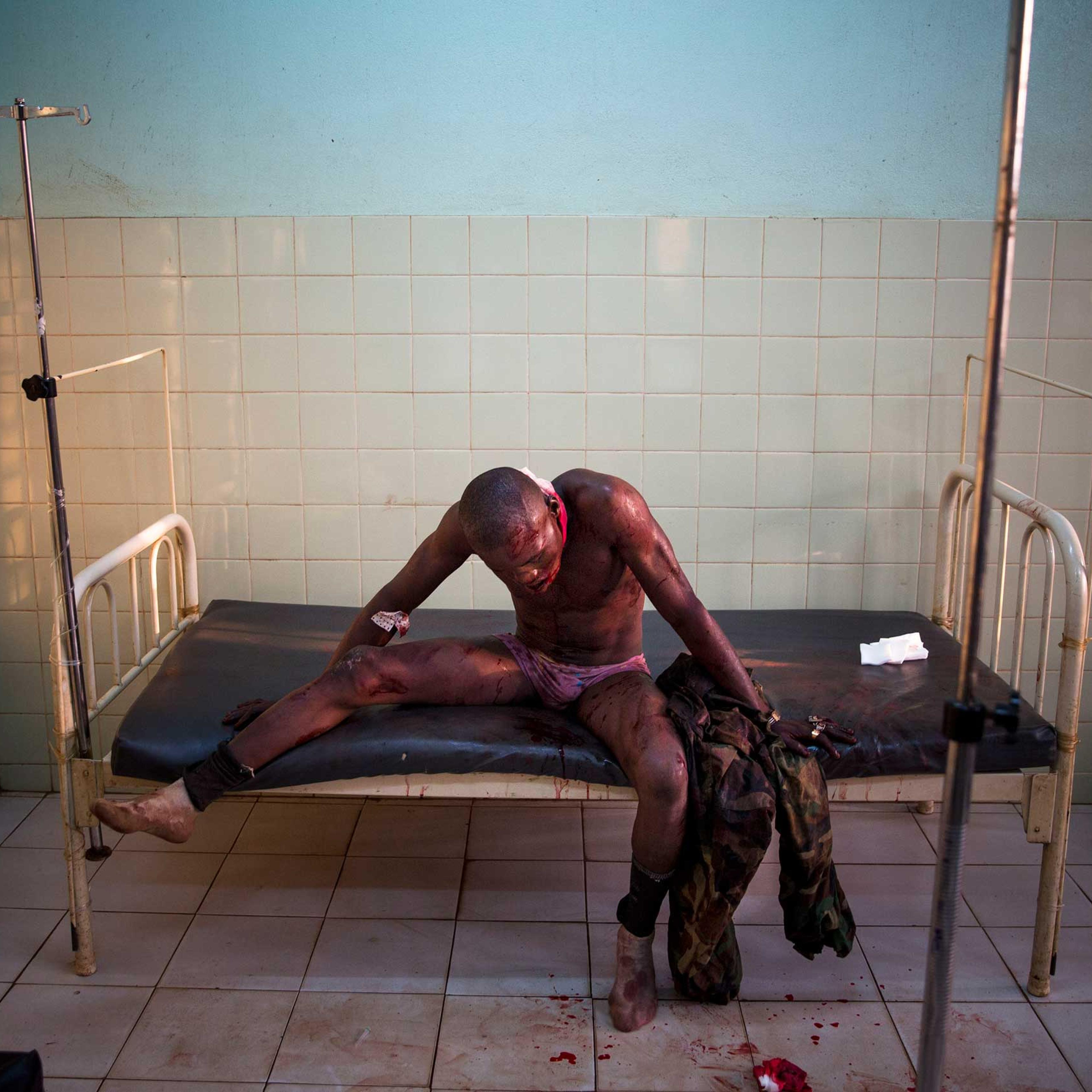 Jan. 31, 2014: A Central African soldier wounded during fighting with Muslims waits to be treated at the community hospital in Bangui.