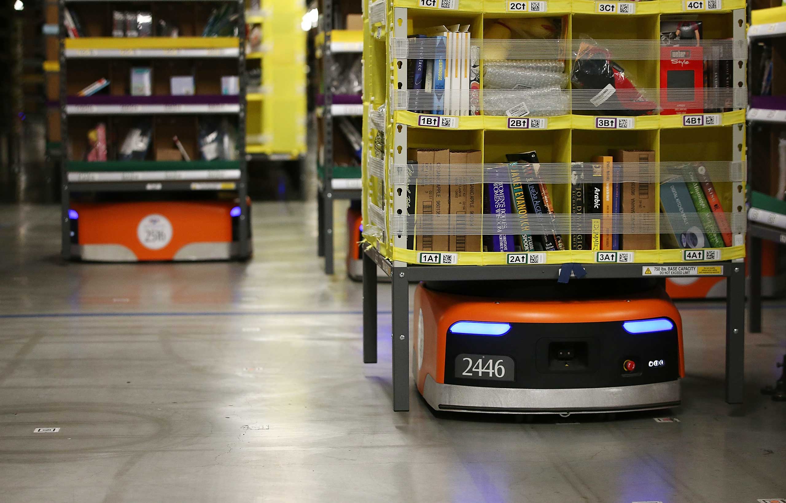 Kiva robots move racks of merchandise at an Amazon fulfillment center on Jan. 20, 2015 in Tracy, Calif.