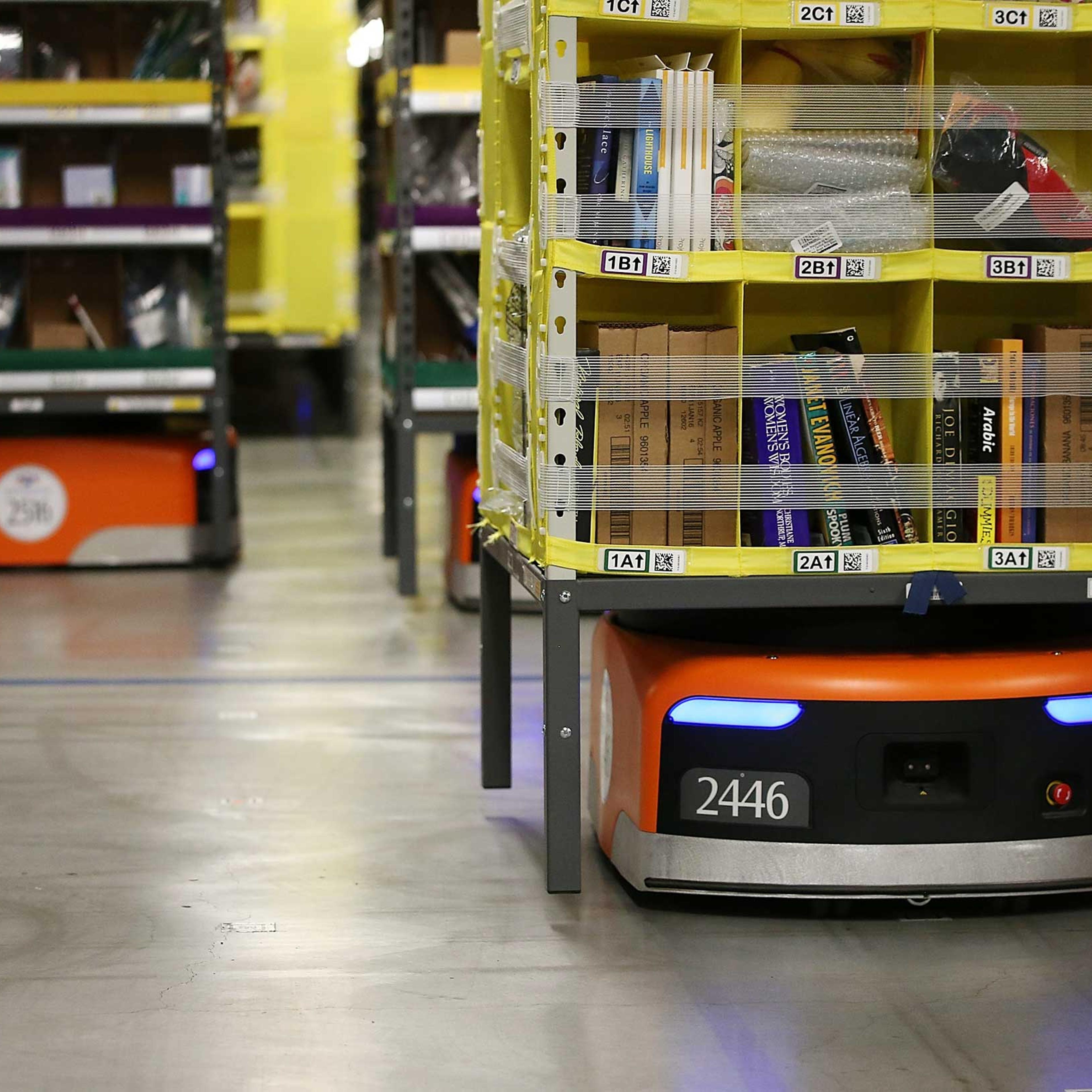Kiva robots move racks of merchandise at an Amazon fulfillment center on Jan. 20, 2015 in Tracy, Calif.