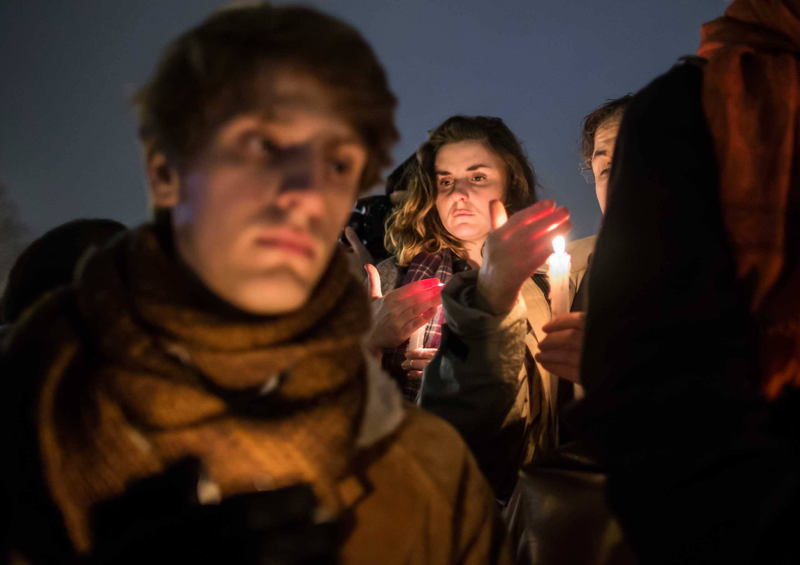 People hold a candle light vigil as thousands gather silently on 'Place de la Republique' in central Paris hours after the attack by masked gunmen on the 'Charlie Hebdo' headquarters in Paris, Jan. 7, 2015.