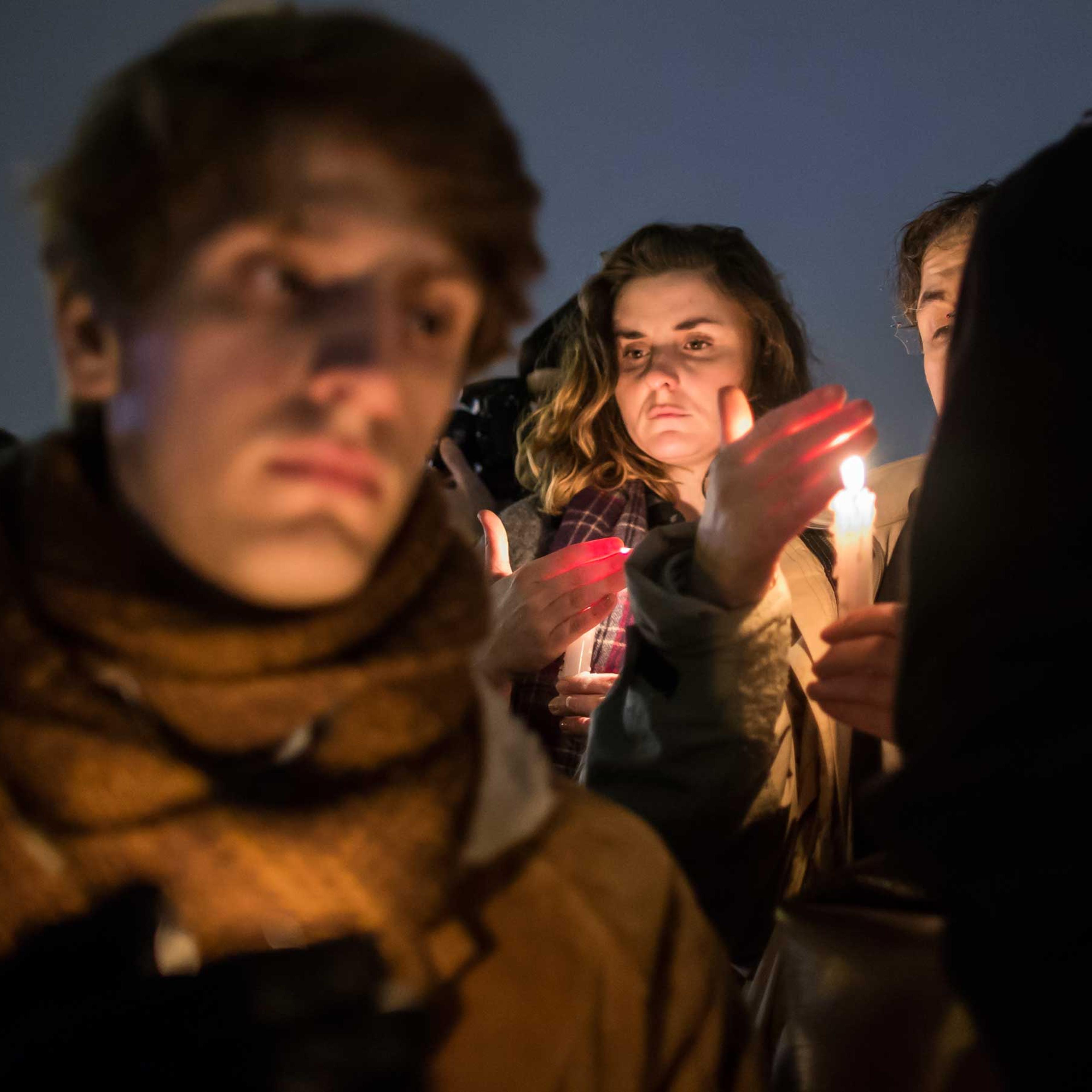 People hold a candle light vigil as thousands gather silently on 'Place de la Republique' in central Paris hours after the attack by masked gunmen on the 'Charlie Hebdo' headquarters in Paris, Jan. 7, 2015.