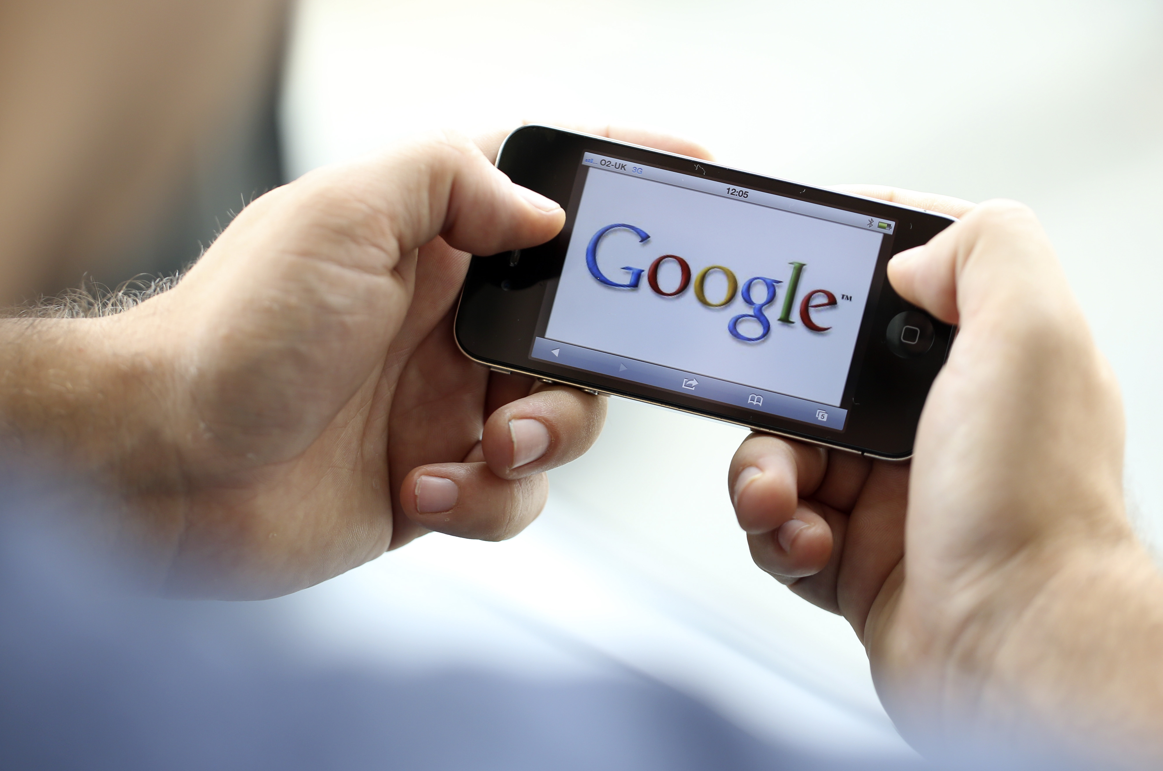 The Google Inc. company logo is seen on an Apple Inc. iPhone 4 smartphone in this arranged photograph in London, U.K., on Wednesday, Aug. 29, 2012.