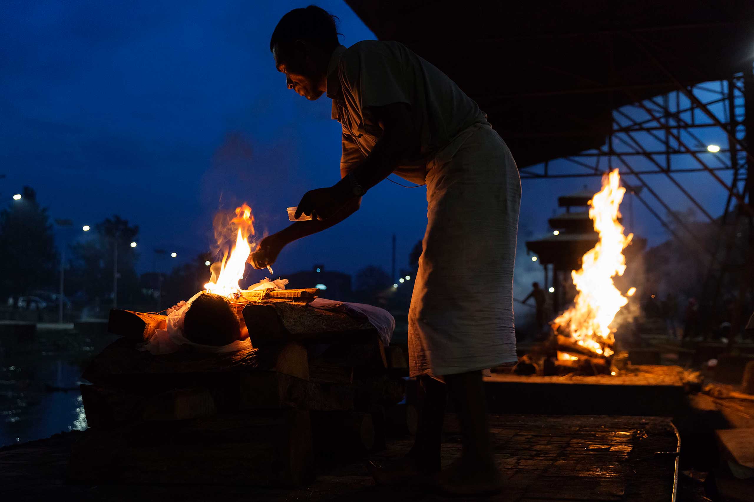 Nepal earthquake. Hindu funeral cremation rituals at Pashupatinath Temple on the Bagmati River in Katmandu. by James Nachtwey