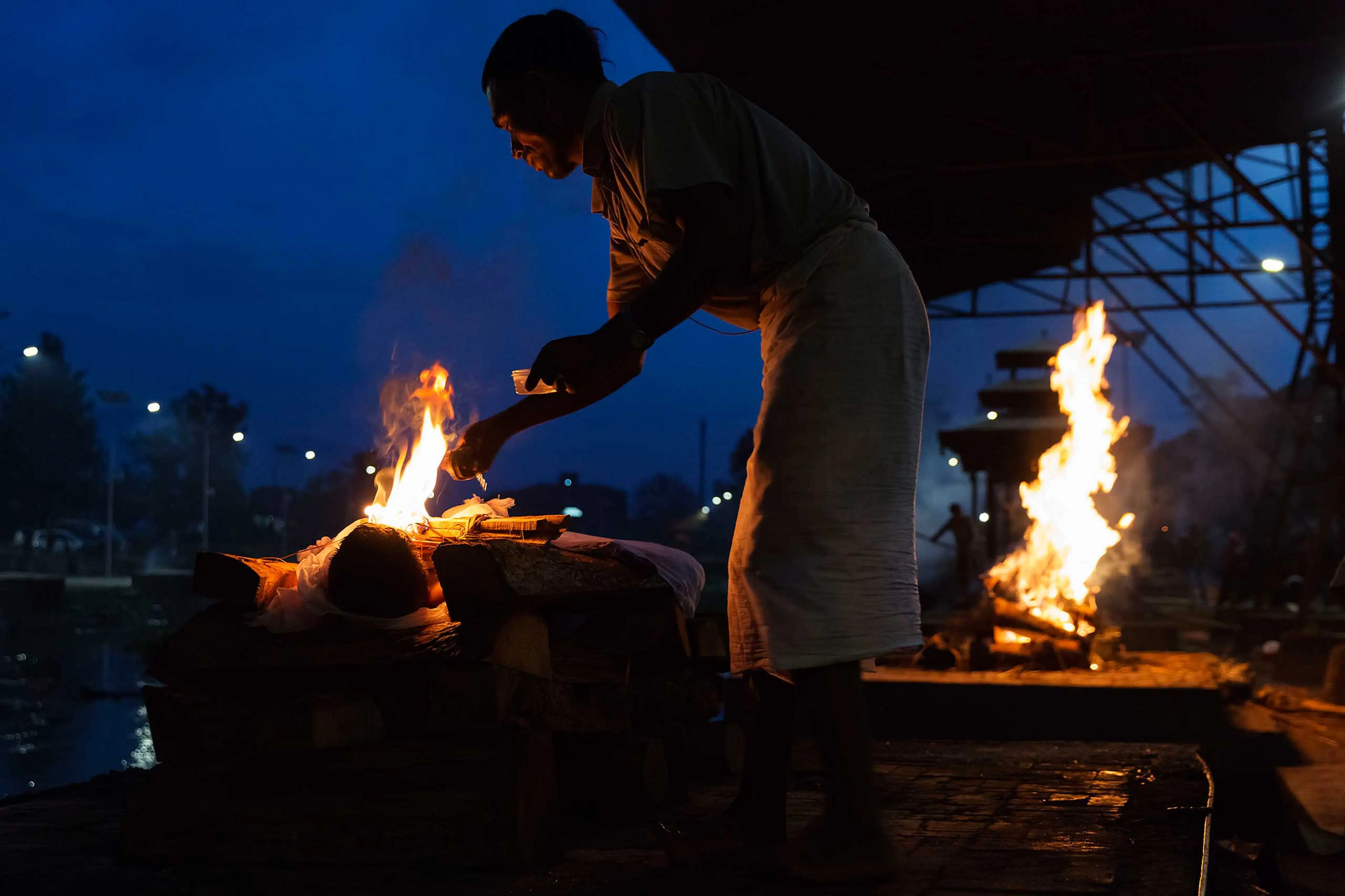 Nepal earthquake. Hindu funeral cremation rituals at Pashupatinath Temple on the Bagmati River in Katmandu. by James Nachtwey