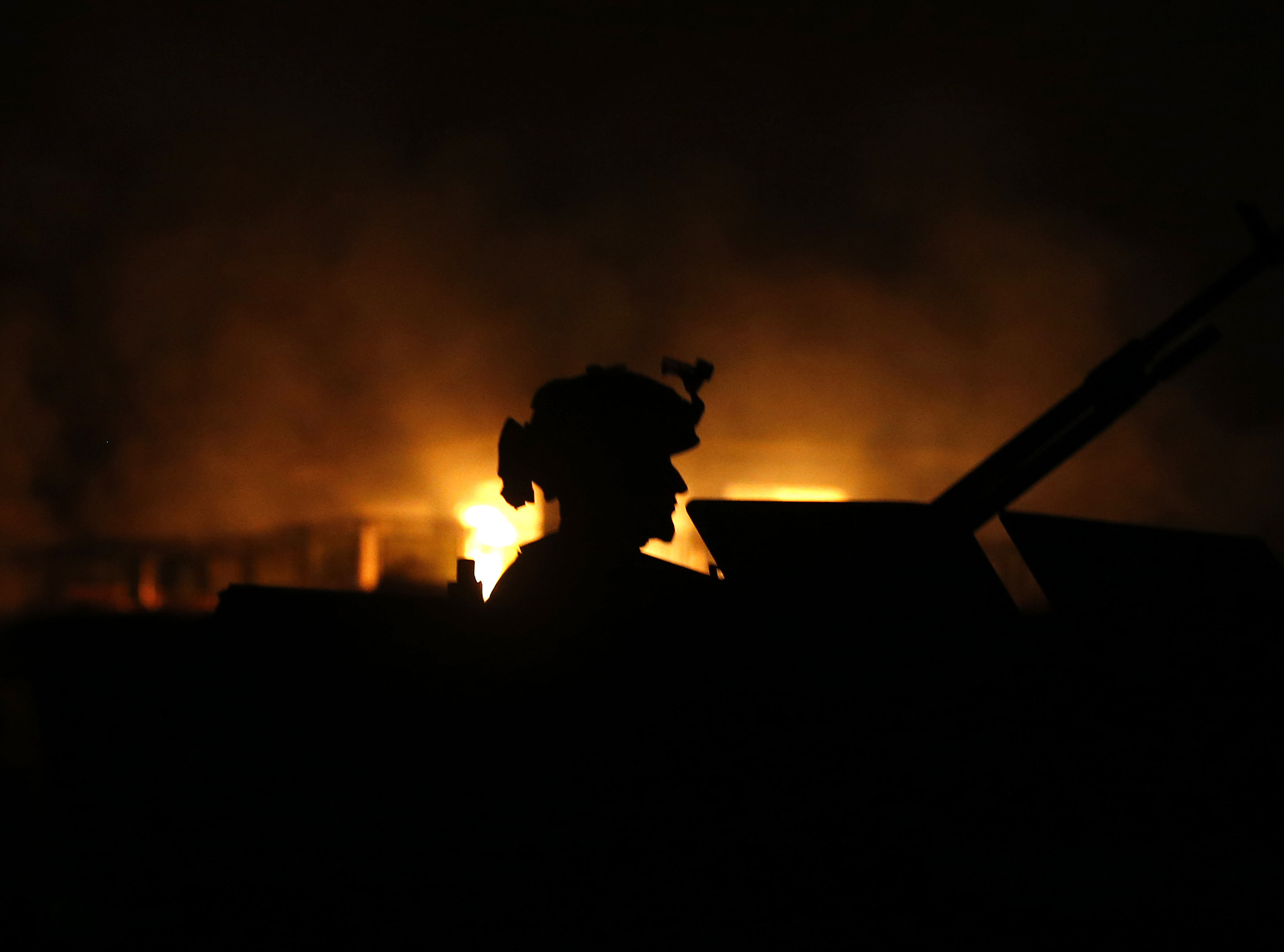 A member of Afghan security forces arrives at the site of a Taliban attack on a foreign aid workers' guest house in the Afghan capital of Kabul