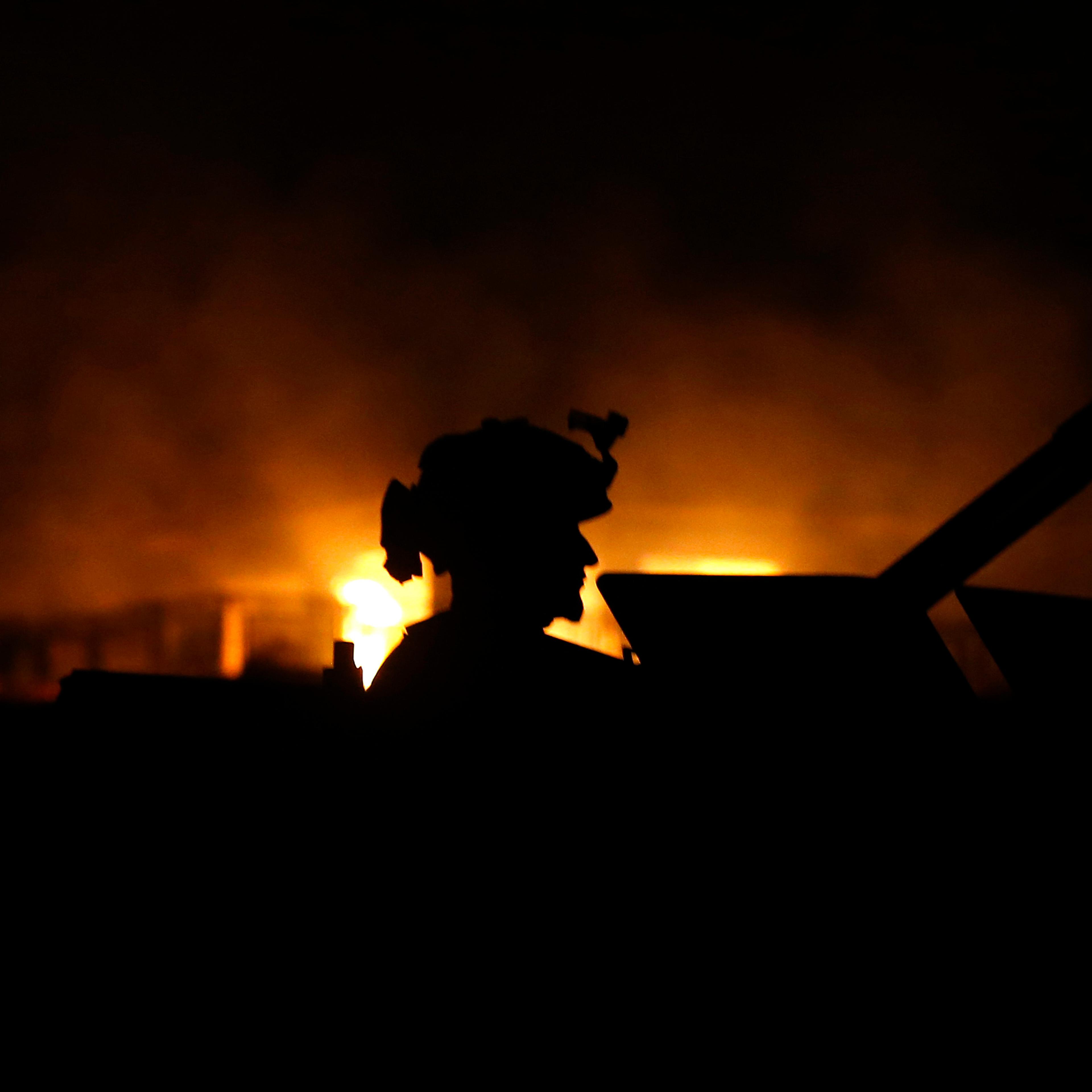 A member of Afghan security forces arrives at the site of a Taliban attack on a foreign aid workers' guest house in the Afghan capital of Kabul