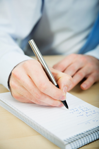 businessman-writing-notebook