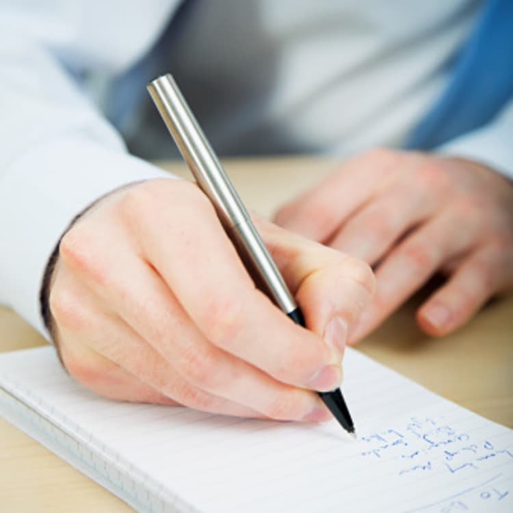 businessman-writing-notebook