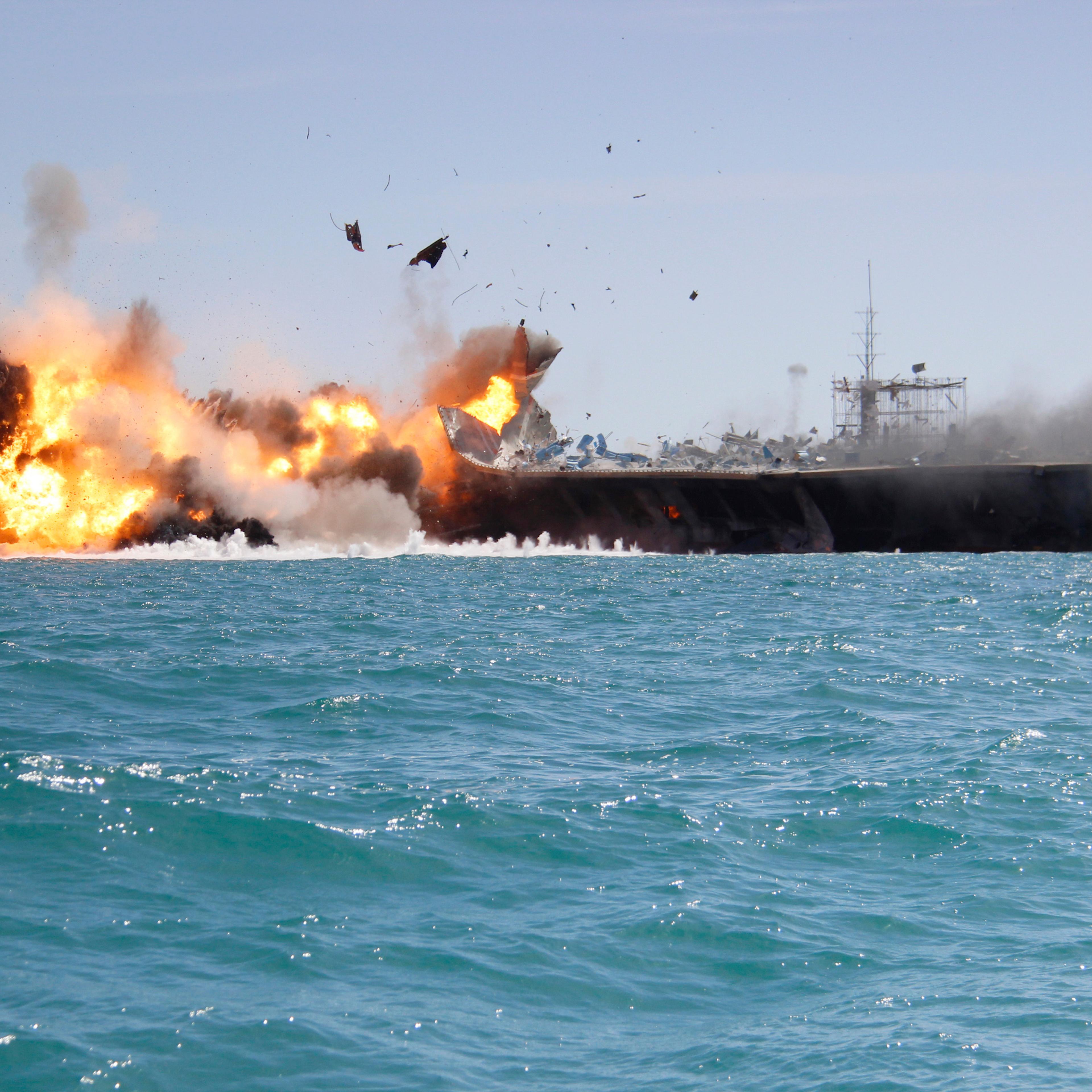 A replica of a U.S. aircraft carrier is exploded by the Revolutionary Guard during naval drills near the entrance of the Persian Gulf, Iran on Feb. 25, 2015.