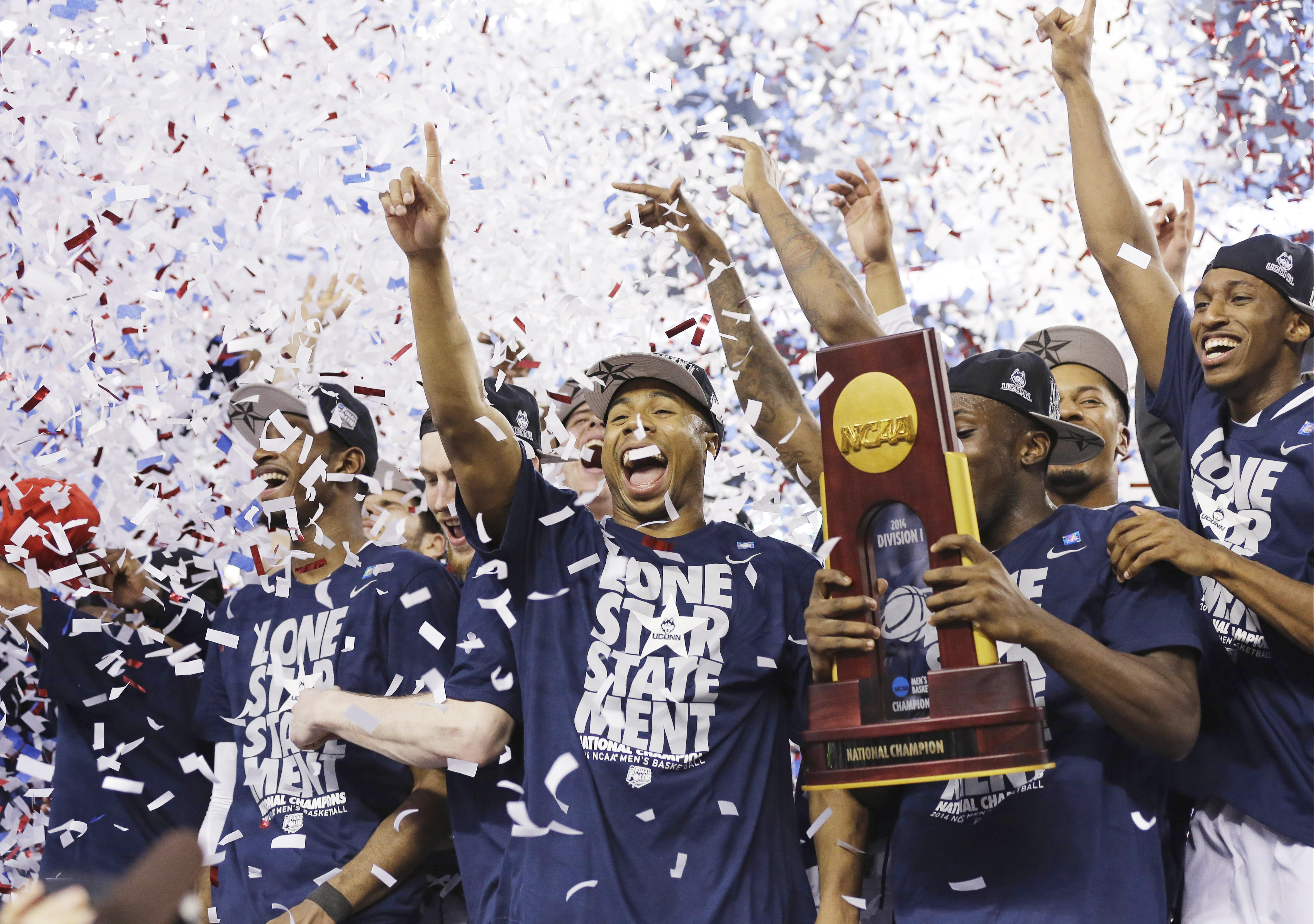 Connecticut celebrates with the championship trophy after beating Kentucky 60-54 at the NCAA Final Four tournament college basketball championship game on April 7, 2014, in Arlington, Texas.