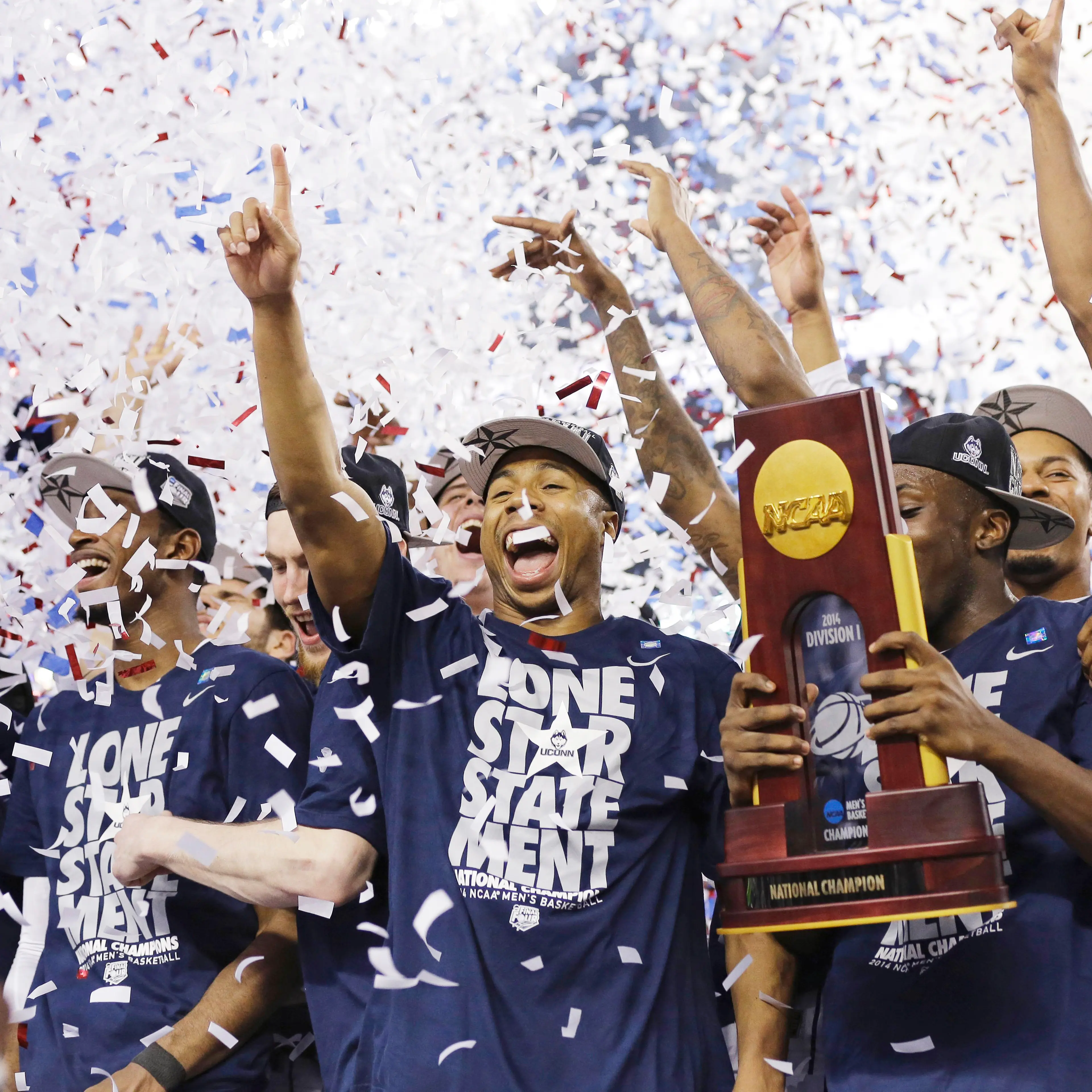 Connecticut celebrates with the championship trophy after beating Kentucky 60-54 at the NCAA Final Four tournament college basketball championship game on April 7, 2014, in Arlington, Texas.