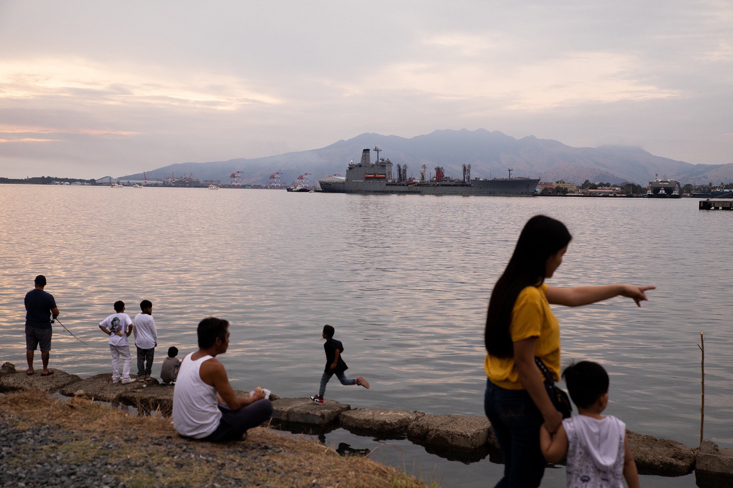 People enjoy the sunset by Malawaan Picnic Park at the Subic Bay Freeport Zone in the province of Zambales, Philippines, on Feb. 20, 2023. 