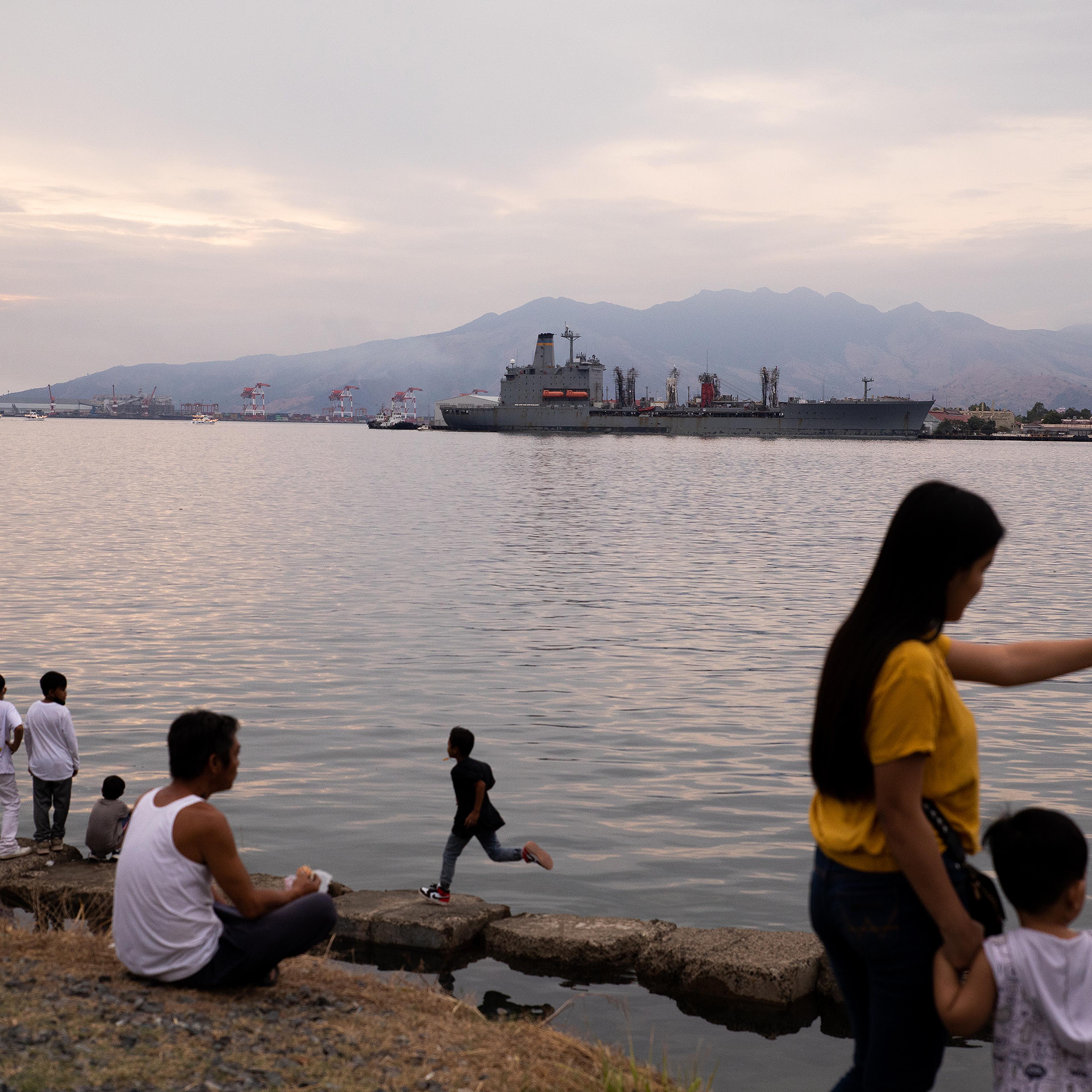 People enjoy the sunset by Malawaan Picnic Park at the Subic Bay Freeport Zone in the province of Zambales, Philippines, on Feb. 20, 2023.