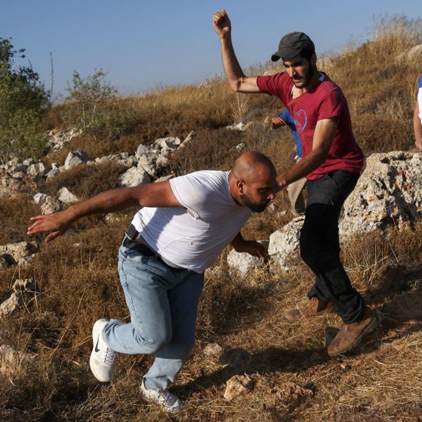 Palestinians scuffle with Israeli settlers who set up tents on lands in Halhoul village north of Hebron in the occupied West Bank, on Aug. 1, 2023.