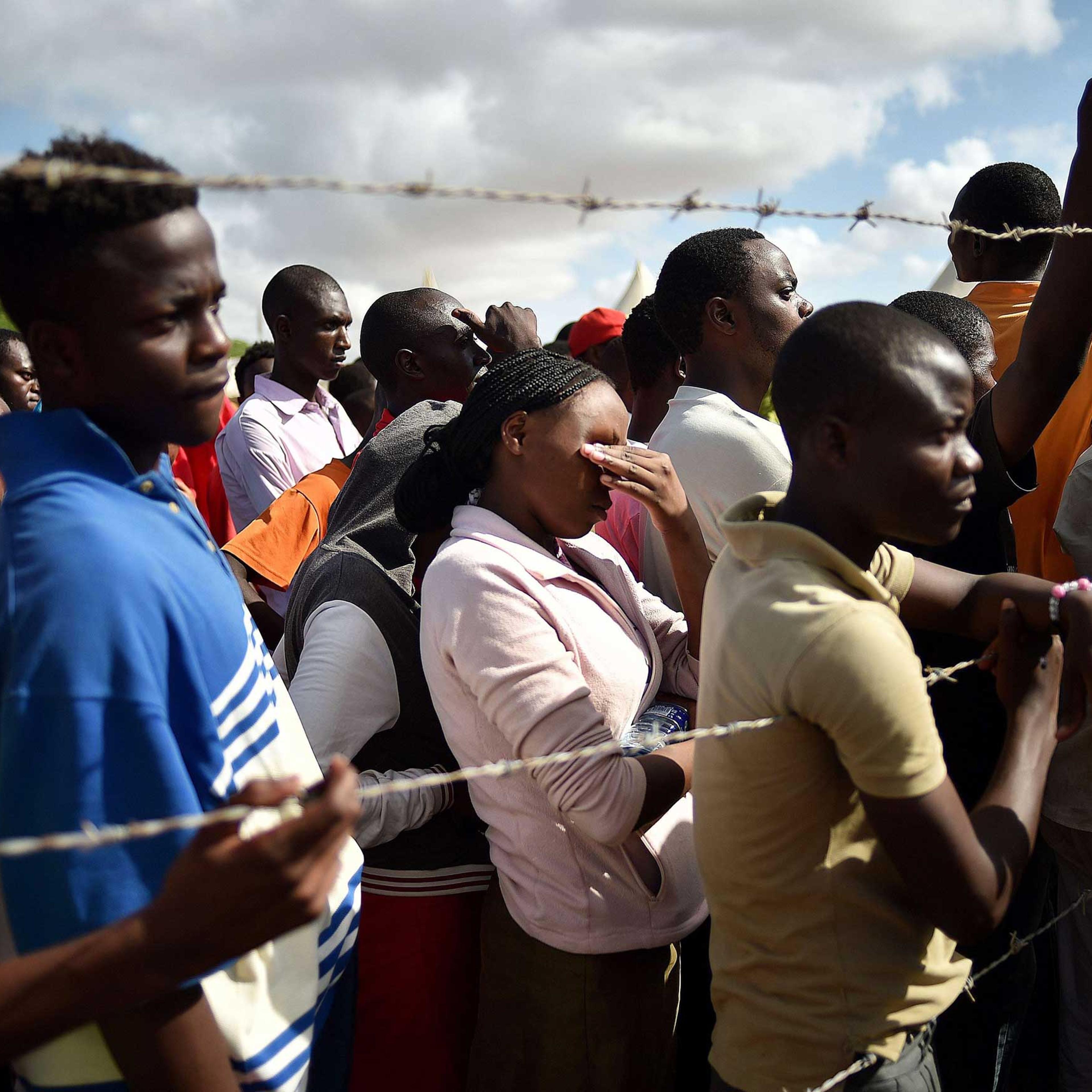 Students evacuated from Garissa University listen to an address by Interior Minister for Security Joseph Ole Nkaissery before they are transported to their home regions from a holding area on April 3, 2015.
