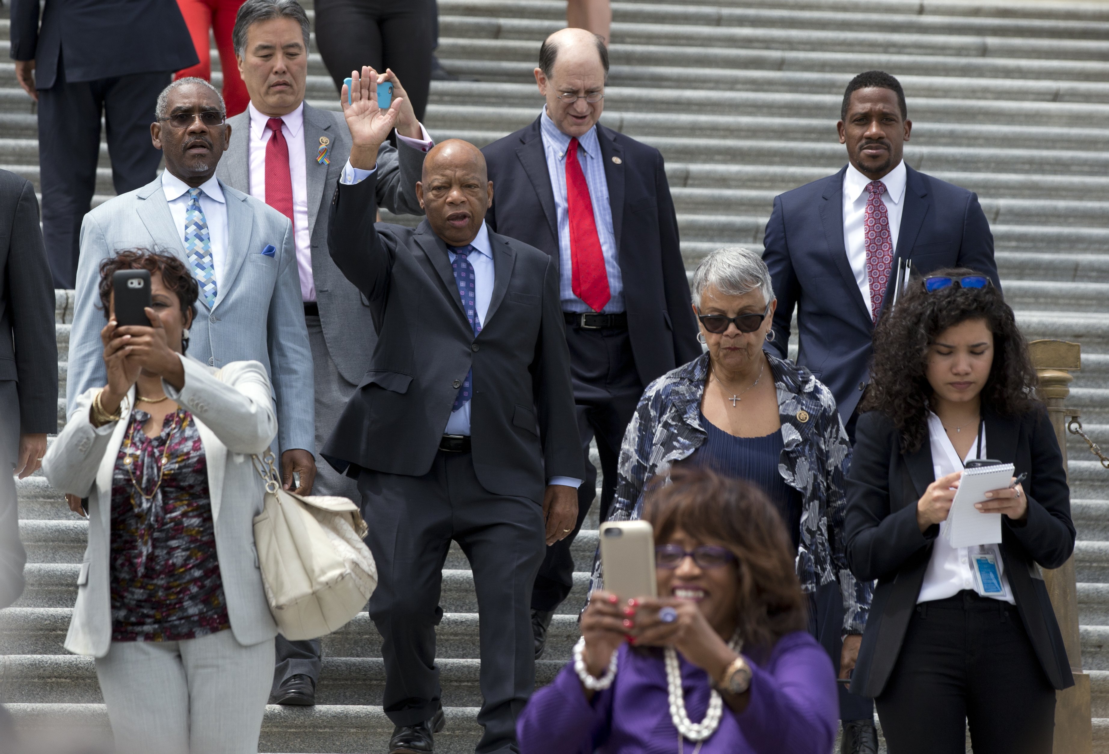 John Lewis waves as he walks down the steps on Capitol Hill in Washington, on June 23, 2016.