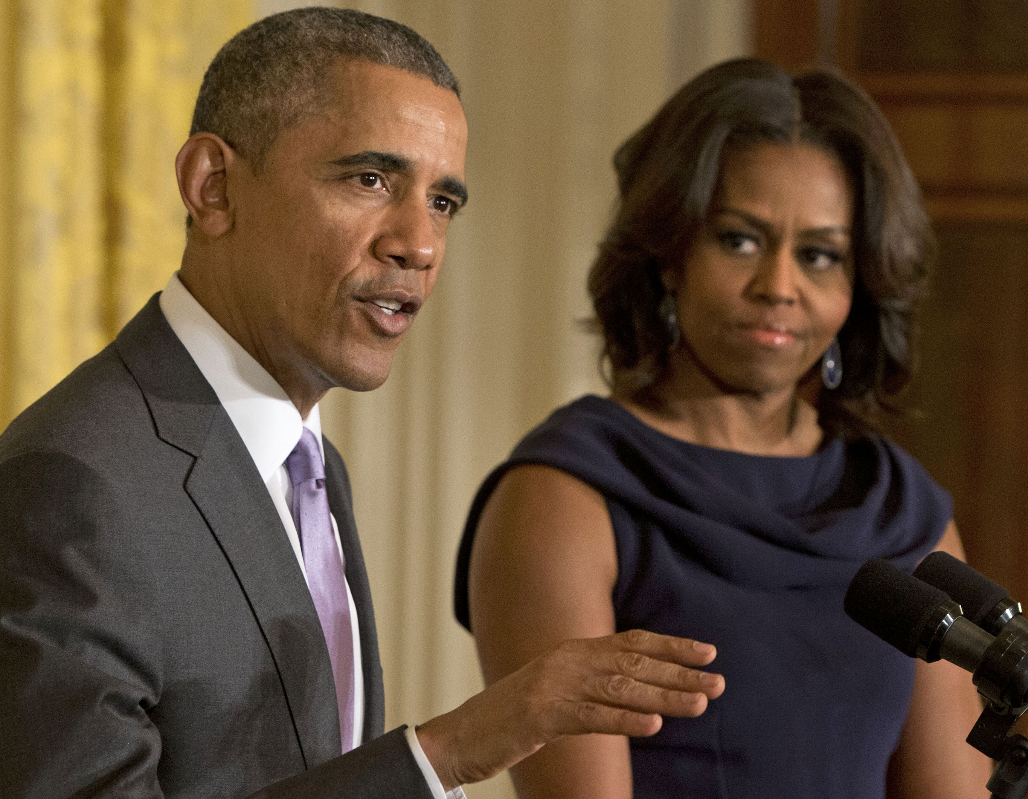 In this March 3, 2015 file photo, President Barack Obama, accompanied by first lady Michelle Obama, speaks in the East Room of the White House in Washington.