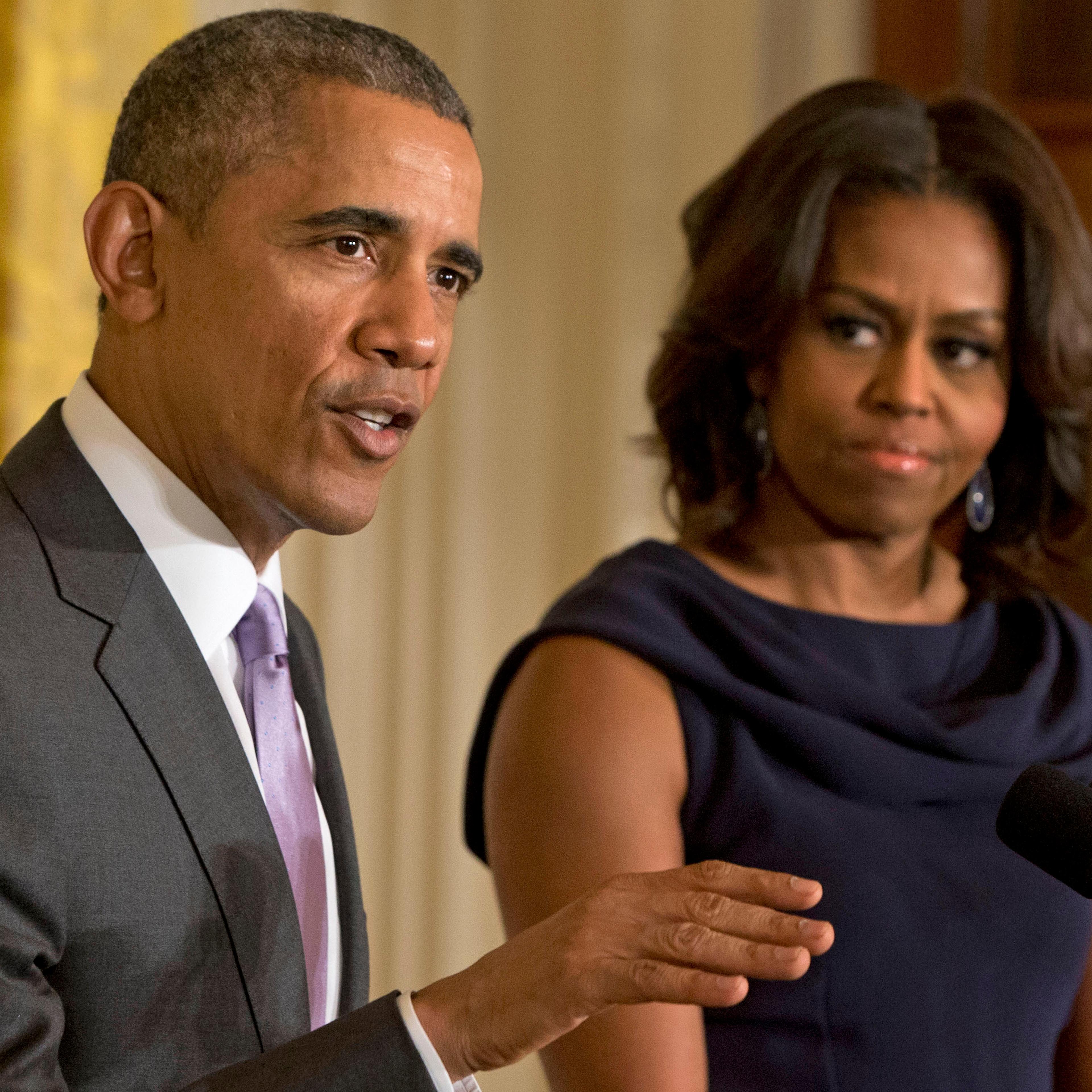 In this March 3, 2015 file photo, President Barack Obama, accompanied by first lady Michelle Obama, speaks in the East Room of the White House in Washington.