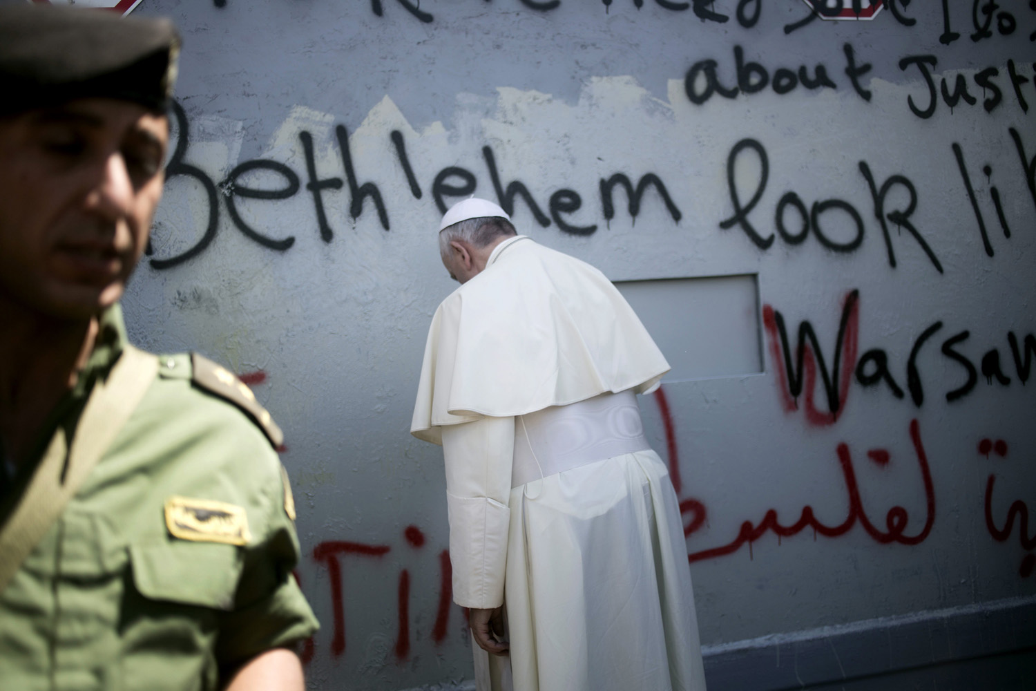 Pope Francis prays at Israel's separation barrier on his way to a mass in Manger Square next to the Church of the Nativity, traditionally believed to be the birthplace of Jesus Christ, in the West Bank town of Bethlehem on May 25, 2014.