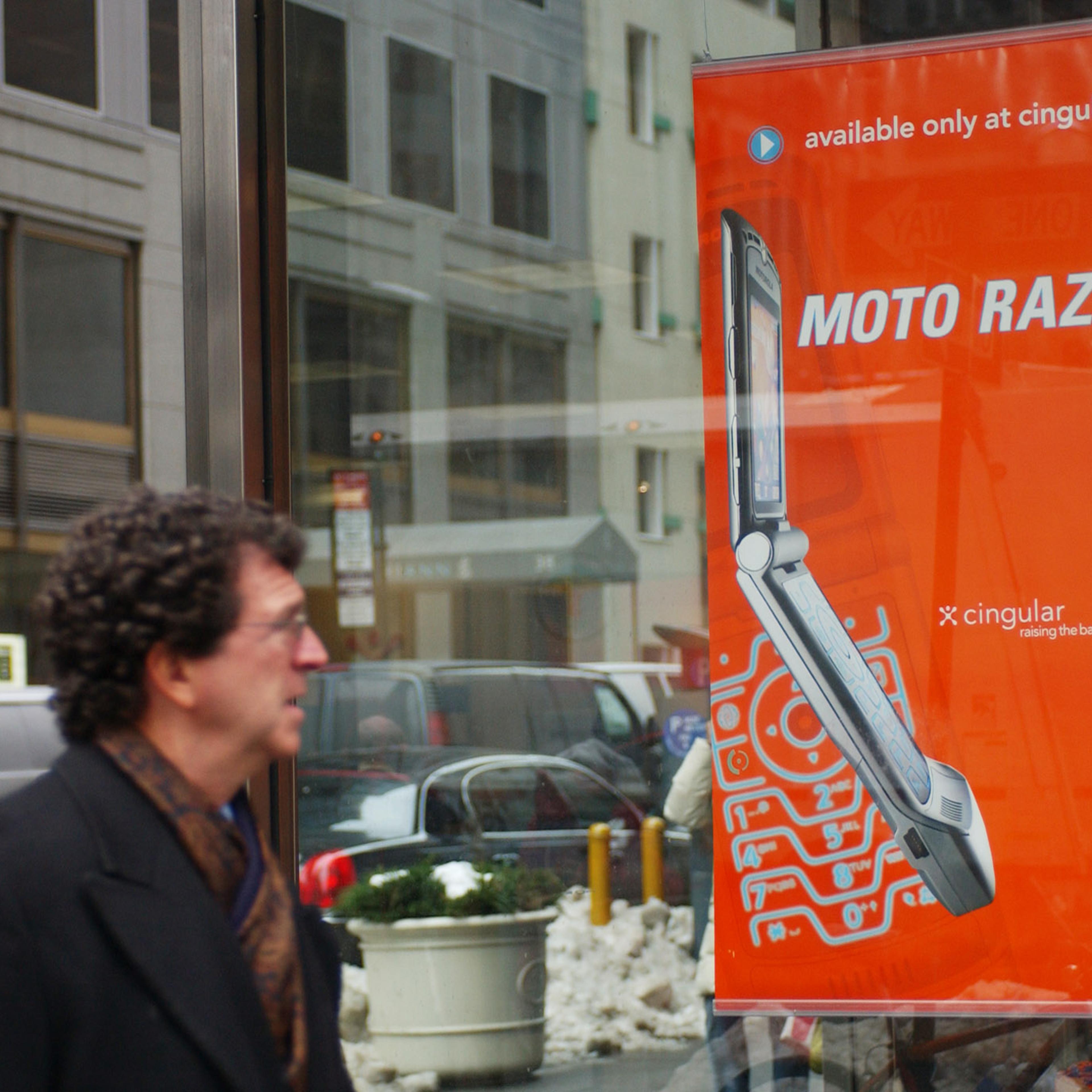 A pedestrian looks at an advertisement for Motorola's new Ra