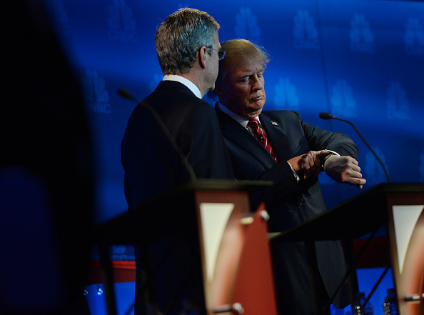 Jeb Bush, left, talks to Donald Trump during a break during the debate.