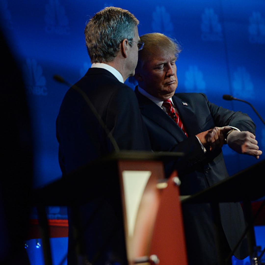 Jeb Bush, left, talks to Donald Trump during a break during the debate.