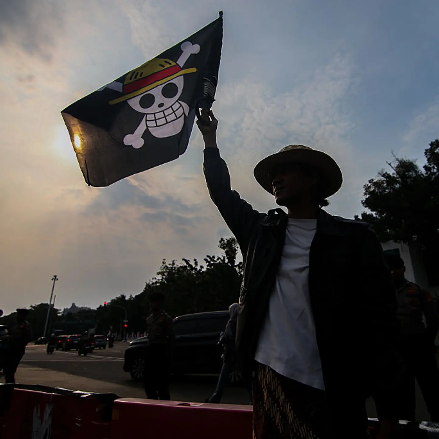 A number of human rights activists carry posters and wave the Straw Hat Pirates' Jolly Roger flag from the anime One Piece during the 873rd Kamisan Action in front of the Merdeka Palace, the Presidential Palace of Indonesia, in Jakarta, Indonesia, on Aug