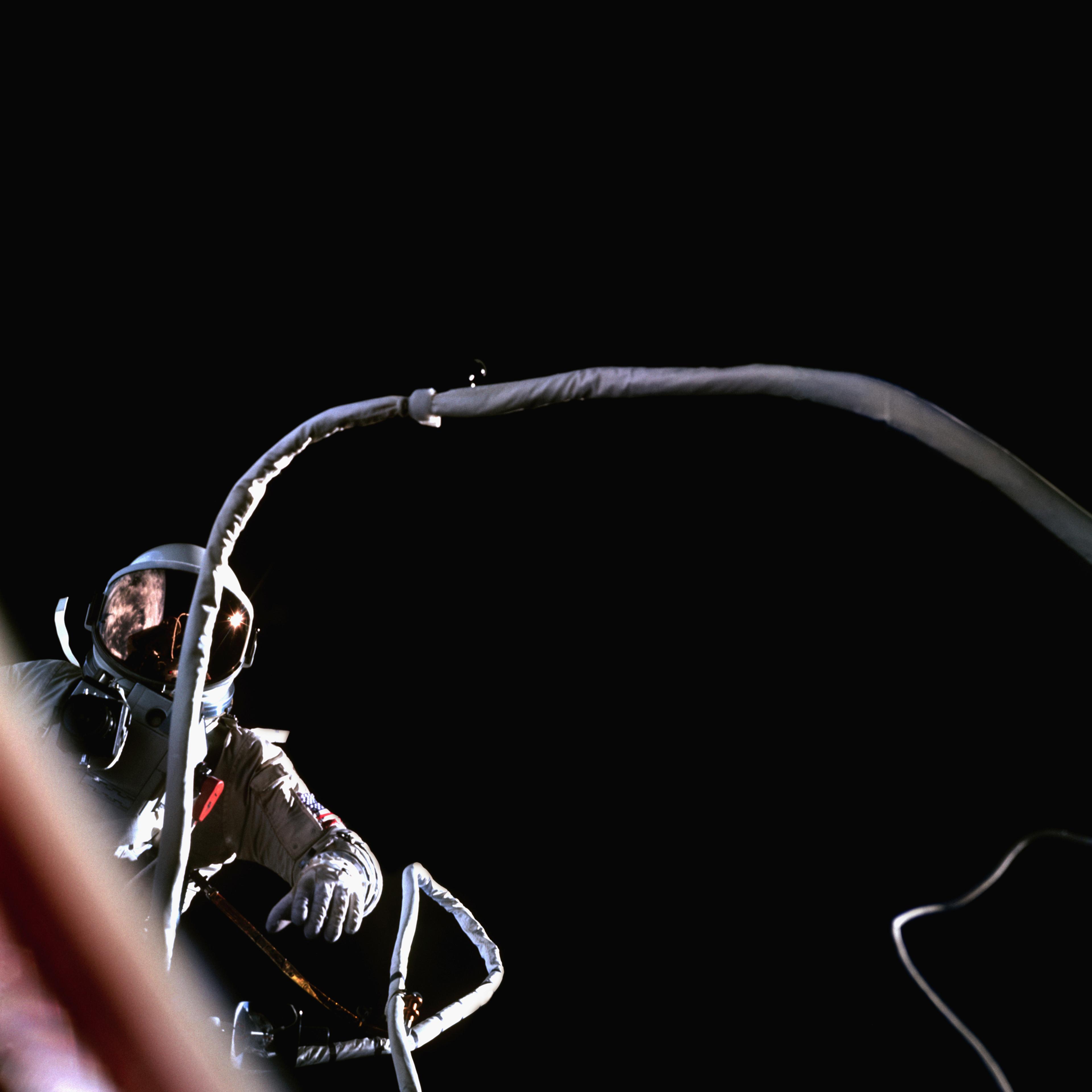 In a view from the Gemini 9 spacecraft, Astronaut Gene Cernan tethered to the Gemini 9 spacecraft as it orbits the Earth.