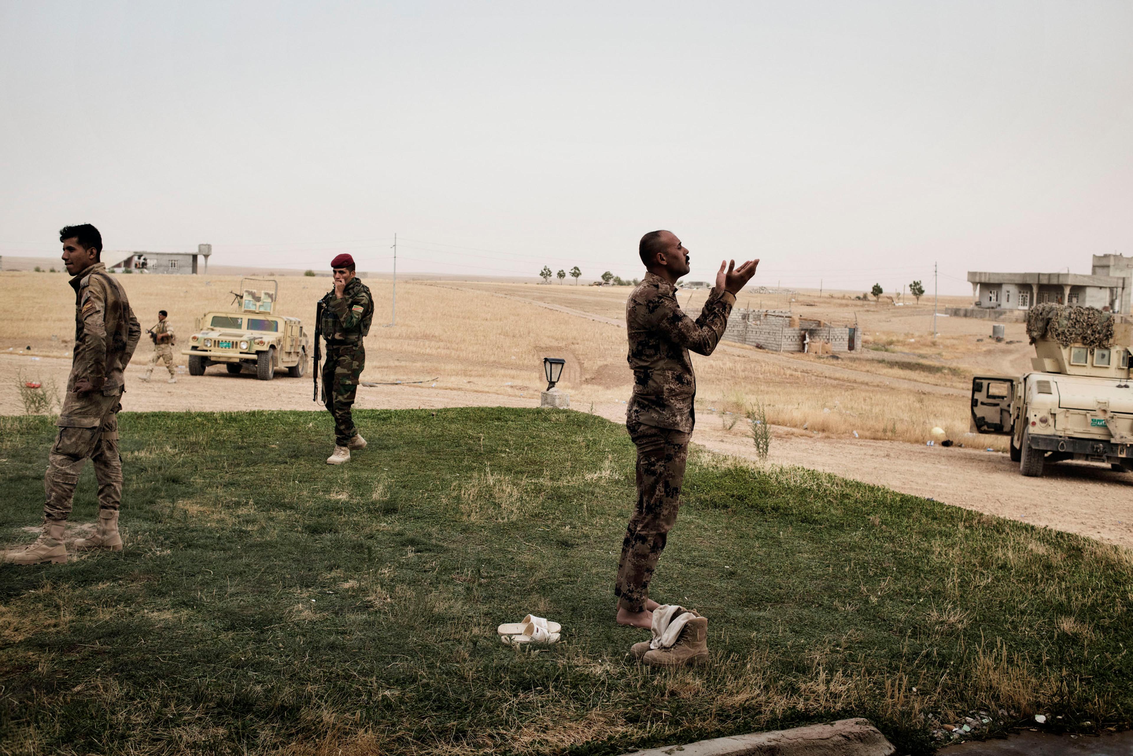 An Iraqi soldier prays south of Mosul, May 18, 2016. The Iraqi military is preparing for a major offensive to retake the city of Mosul from ISIS control.