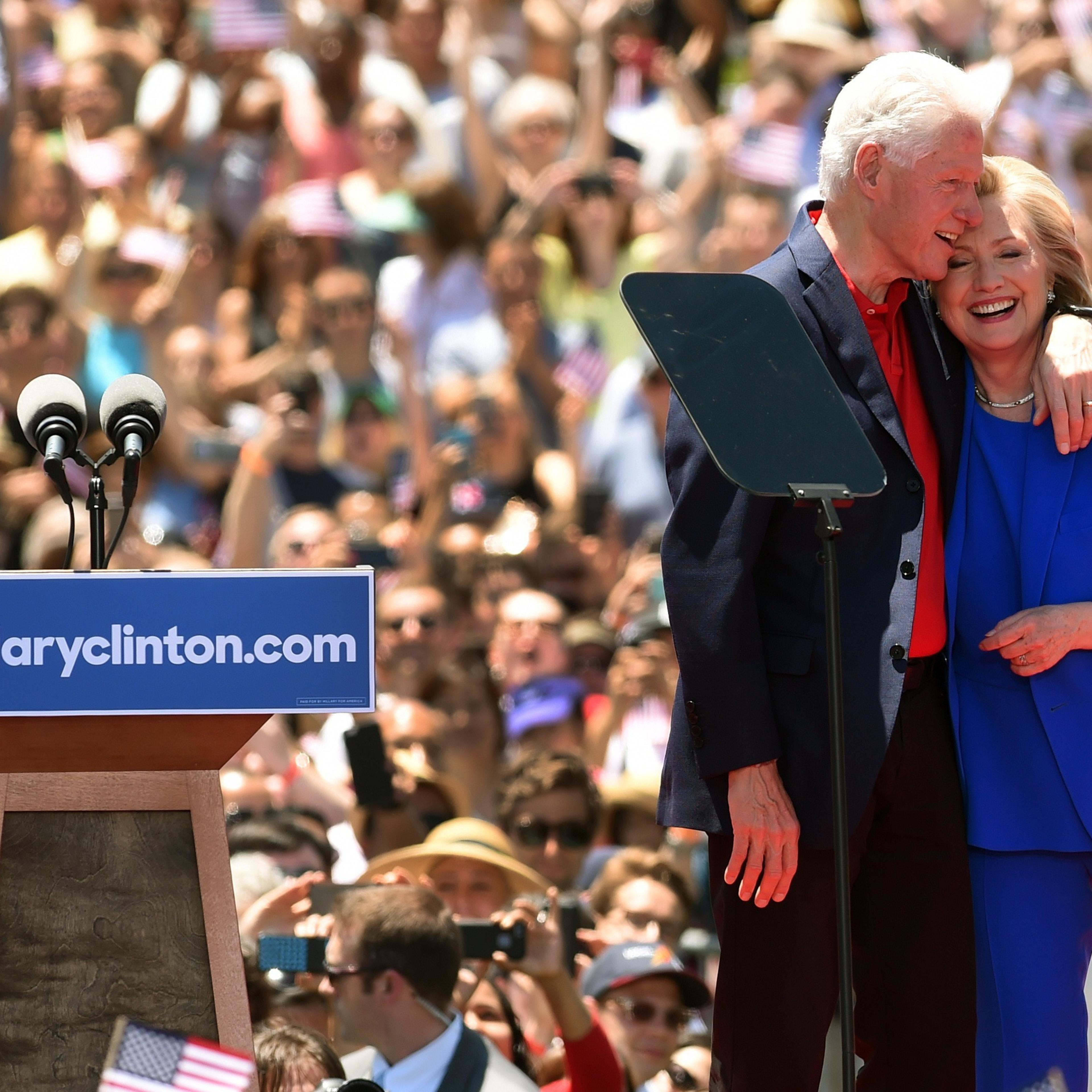Former Secretary of State Hillary Clinton and Former US President Bill Clinton hug after she officially launched her campaign for the Democratic presidential nomination during a speech at the Franklin D. Roosevelt Four Freedoms Park in New York on June 1