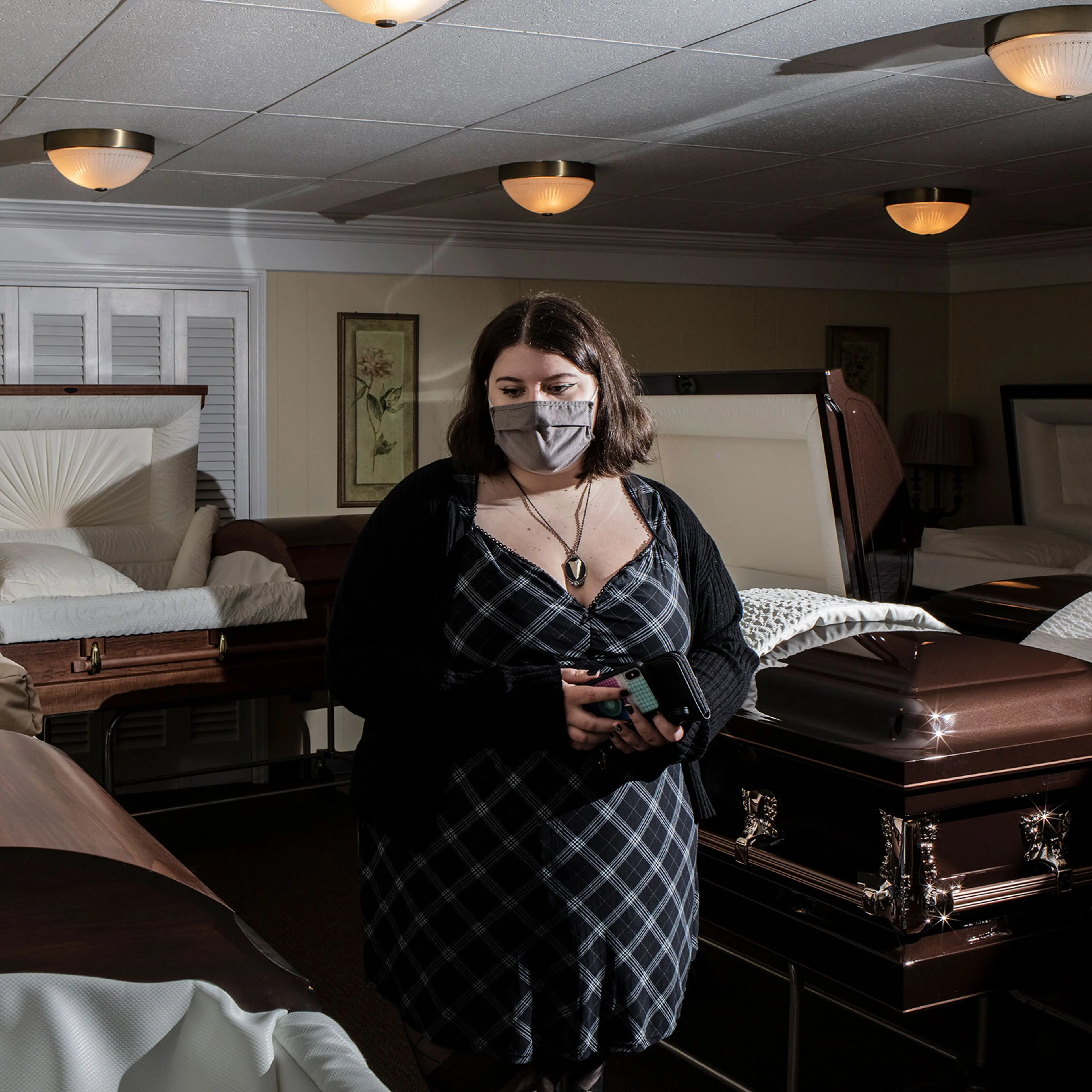 A student examines a casket during a Kean University course on death at Galante Funeral Home in Union, N.J., on Wednesday, February 2, 2022.CREDIT: Bryan Anselm/Redux for TIME