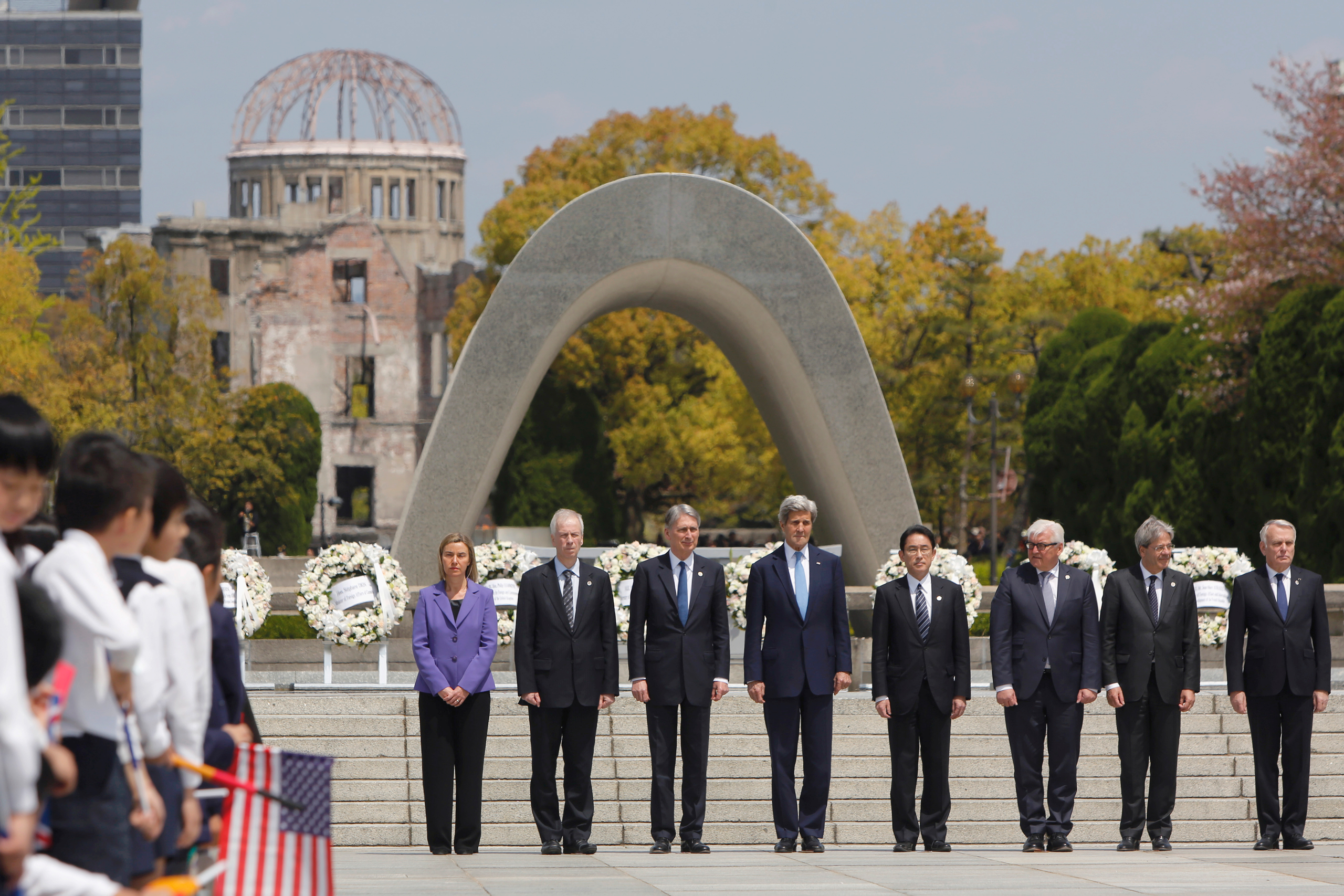G7 foreign ministers stand together after placing wreaths at the cenotaph at Hiroshima Peace Memorial Park in Hiroshima, western Japan on April 11, 2016. Pictured from left are E.U. High Representative for Foreign Affairs Federica Mogherini, Canada's For