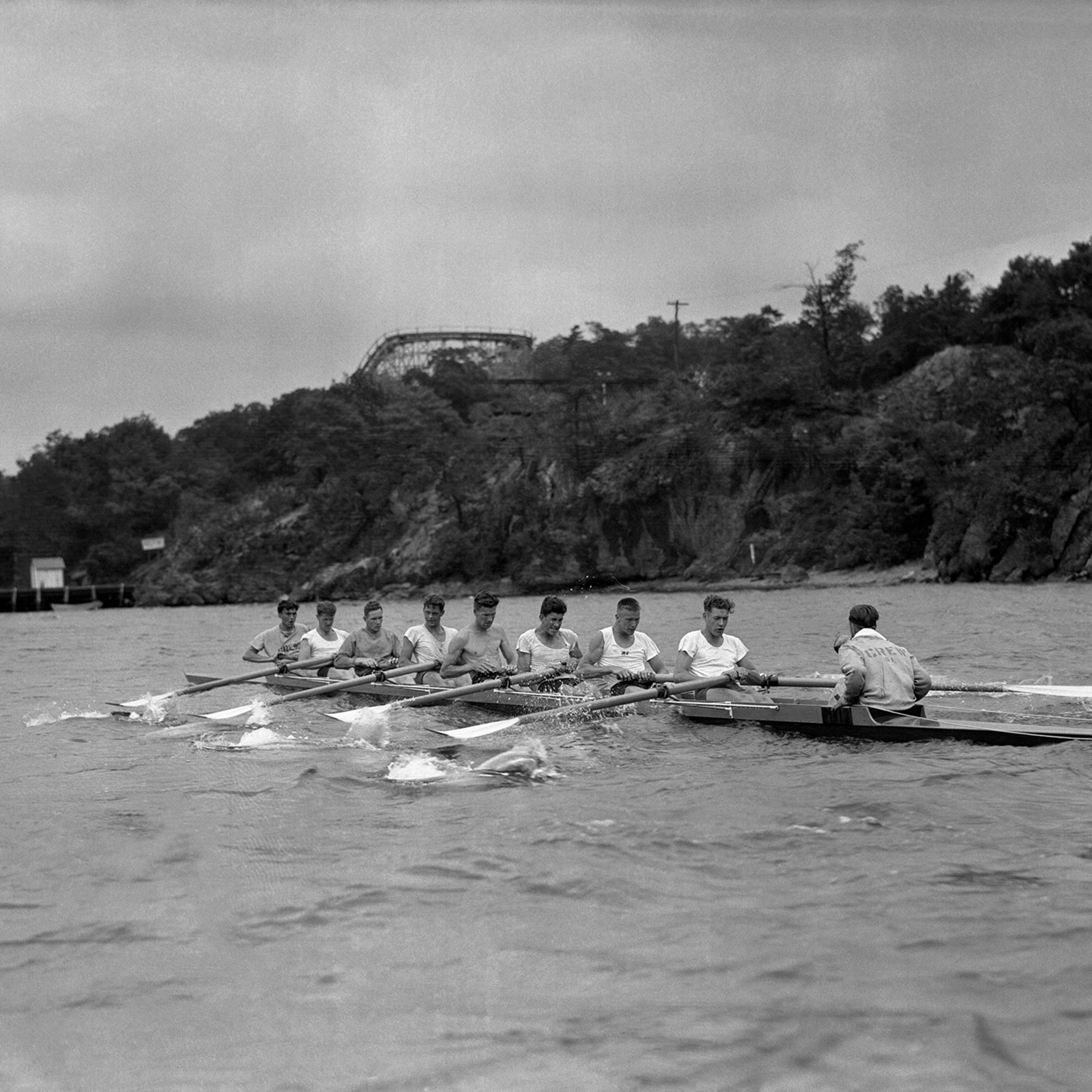 The University of Washington's varsity crew team at the Poughkeepsie Regatta Races in June 1936. Pictured from right to left: Bob Moch, Coxwain; Don Hume, Stroke; Joe Rantz, 7; George Hunt, 6; Jim McMillin, 5; John White, 4; Gordon Adams, 3; Charles Day, 2; and Roger Morris, 1.