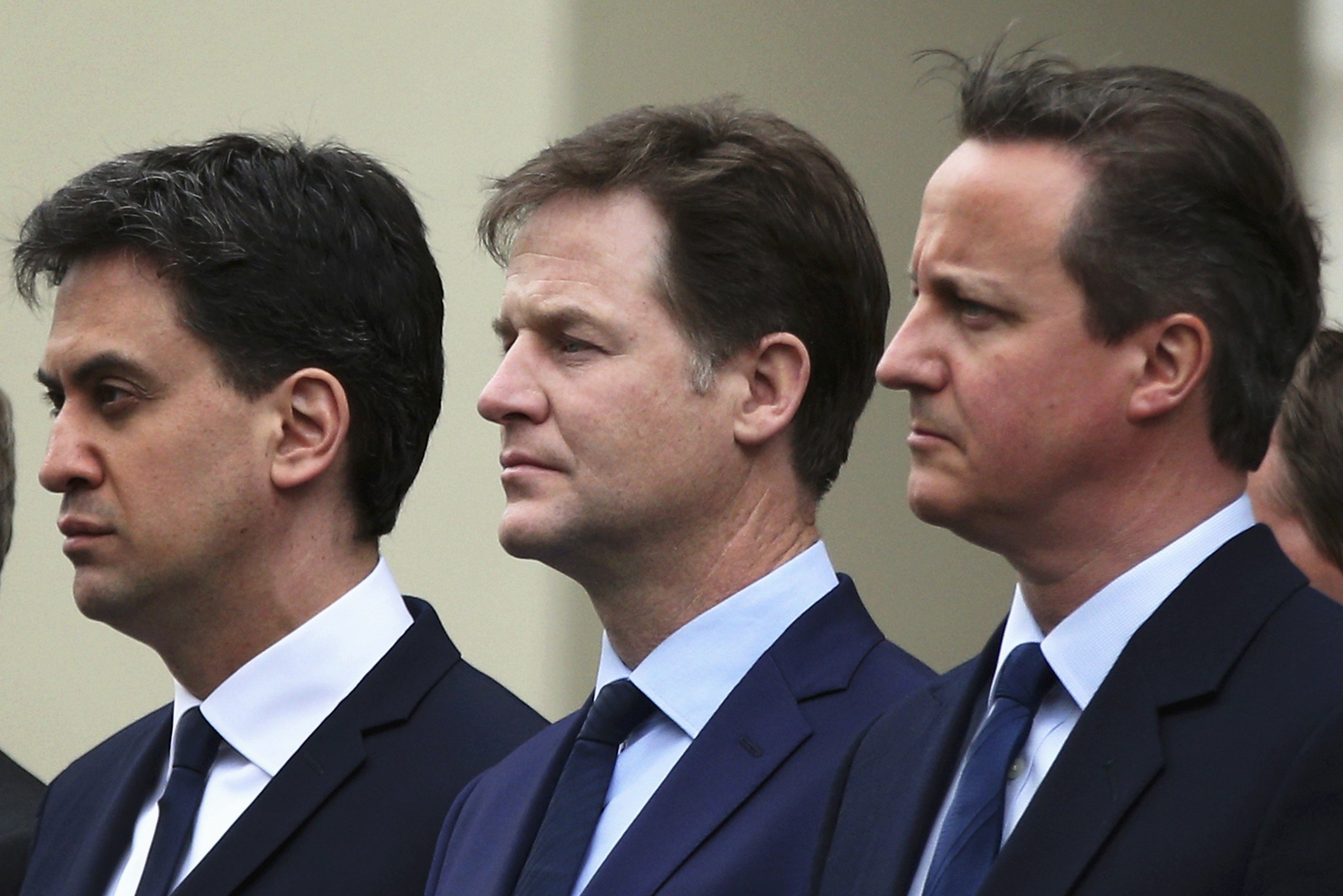 Britain's Prime Minister David Cameron (R) stands with former former Liberal Democrat leader Nick Clegg (C) and former Labour Party leader Ed Miliband, as they line up to pay tribute at the Cenotaph during a Victory in Europe (VE) day ceremony in central